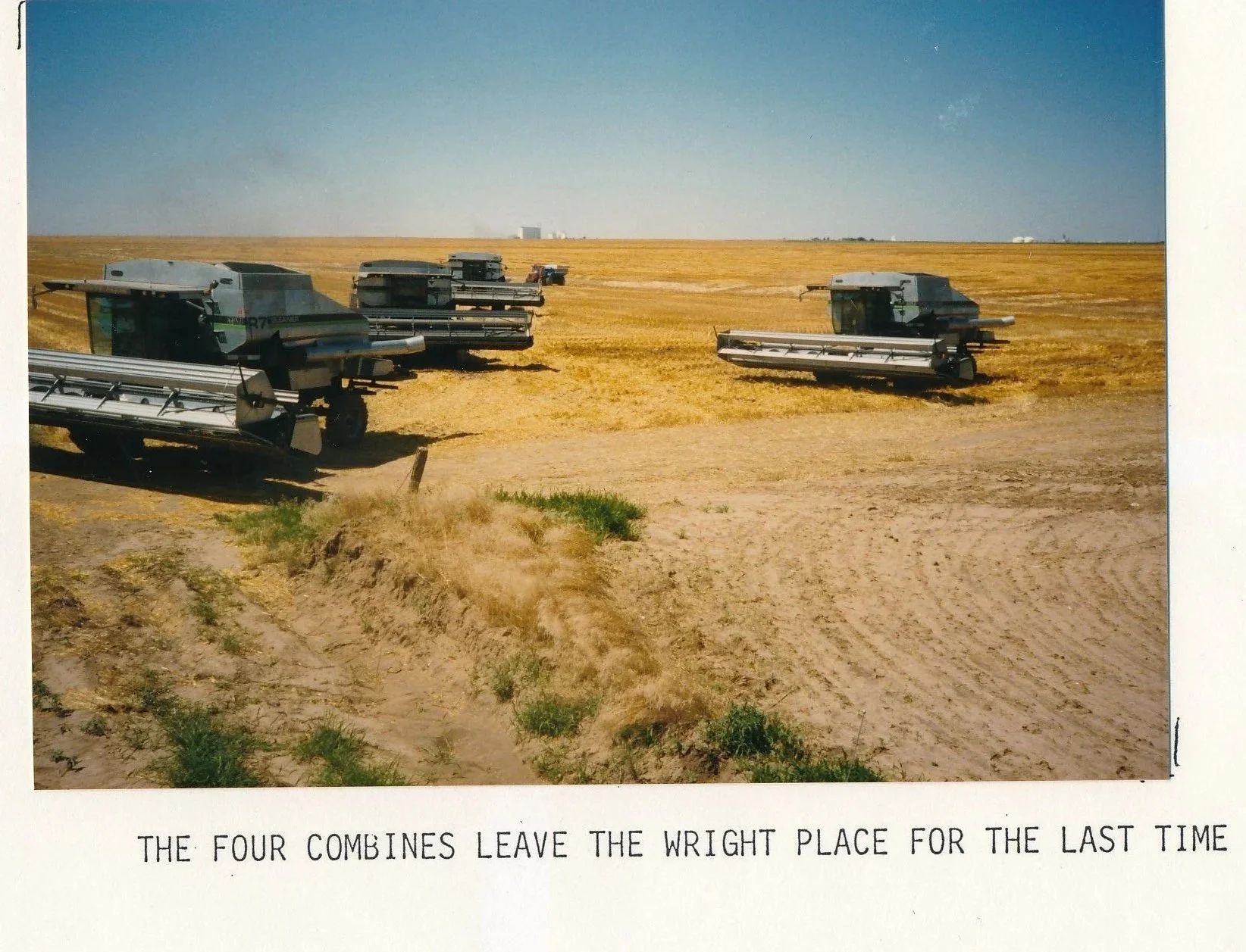 Four combine harvesters leaving a field, with text at the bottom reading, "The four combines leave the wright place for the last time."