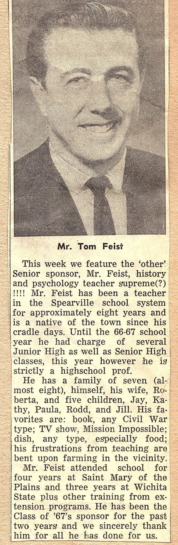 Black and white photo of Mr. Tom Feist, a young man in a suit and tie, smiling. Text below introduces him as a history and psychology teacher, mentioning his background, family, favorite activities, and his role as a sponsor for the school.
