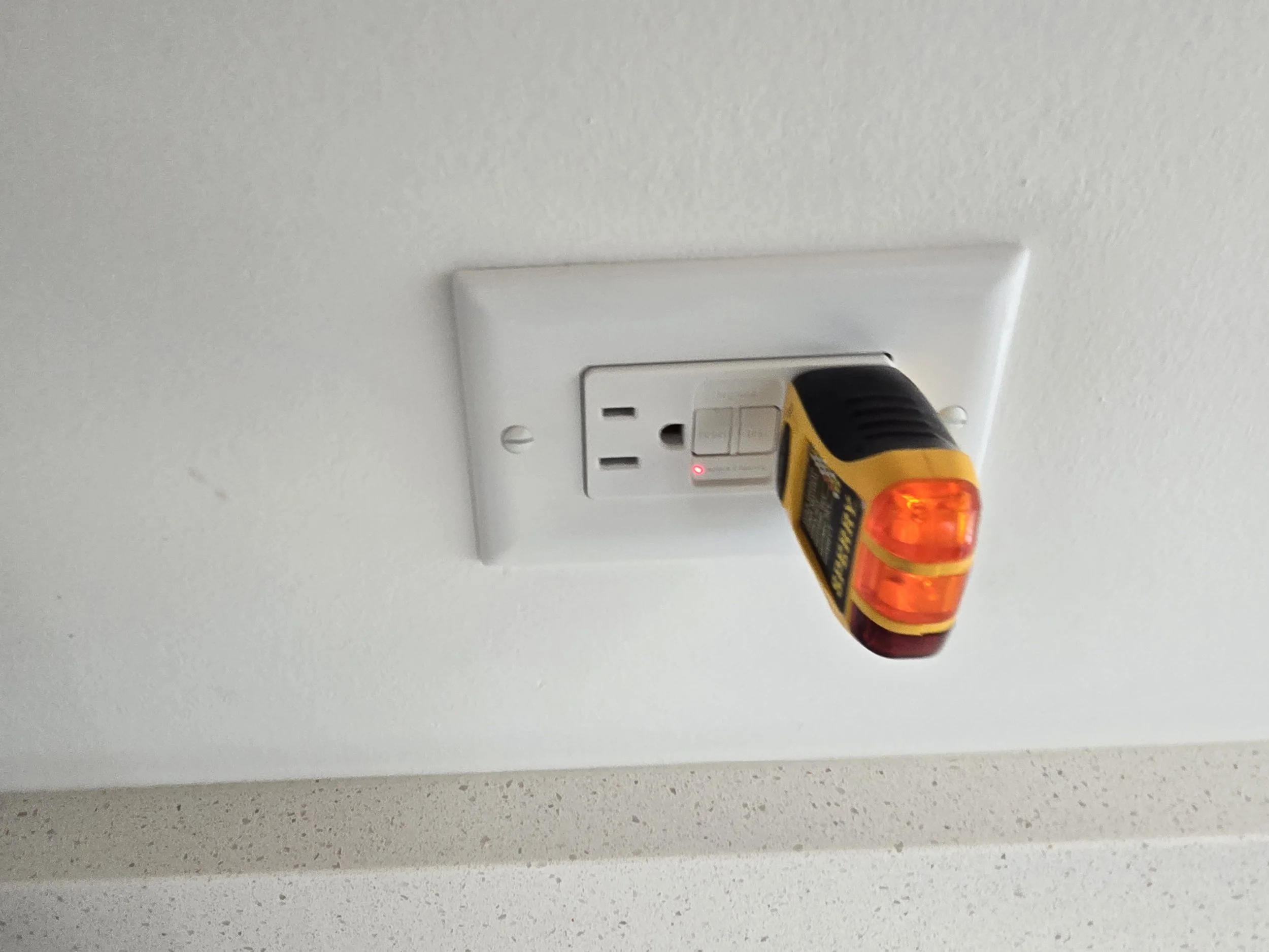 Defective GFCI outlet with a red indicator light that failed to trip during testing during a professional home inspection in Illinois.