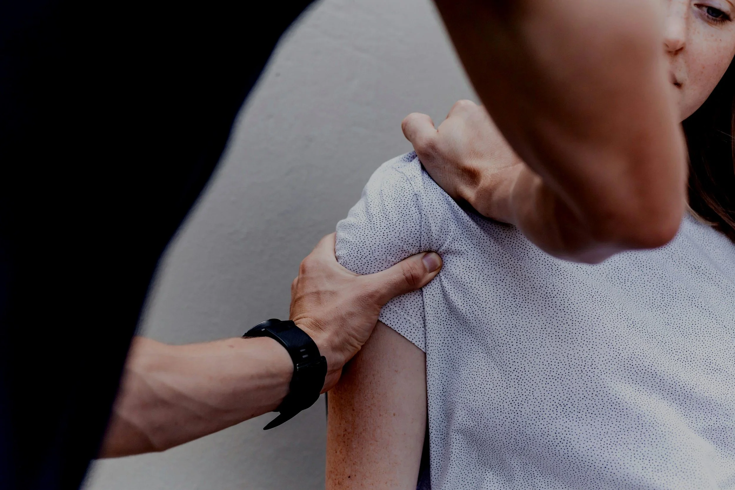 A healthcare professional administering a vaccine to a woman in her upper arm.