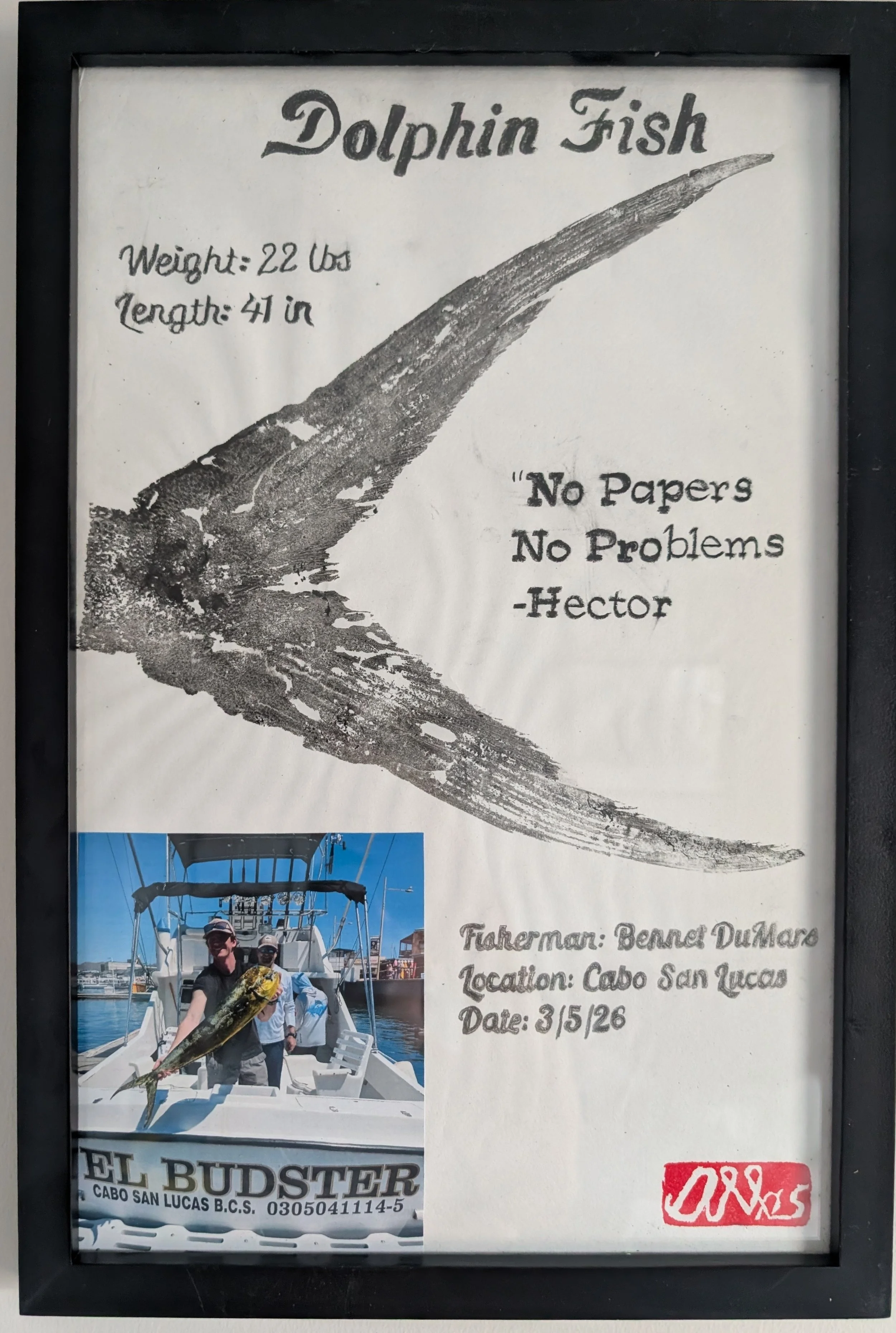 A framed sign featuring a large illustration of a dolphin fish, details about a catch including weight of 22 pounds and length of 41 inches, a quote 'No Papers No Problems' by Hector, and a smaller photo of two people on a boat holding a large fish, 
