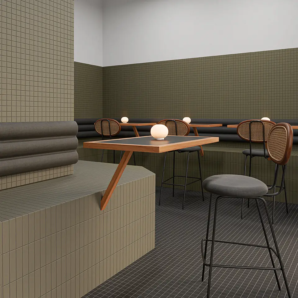 Interfaz moderna de restaurante con mesas y sillas de diseño minimalista, paredes decoradas con baldosas en tonos neutros y lámparas blancas en las mesas.