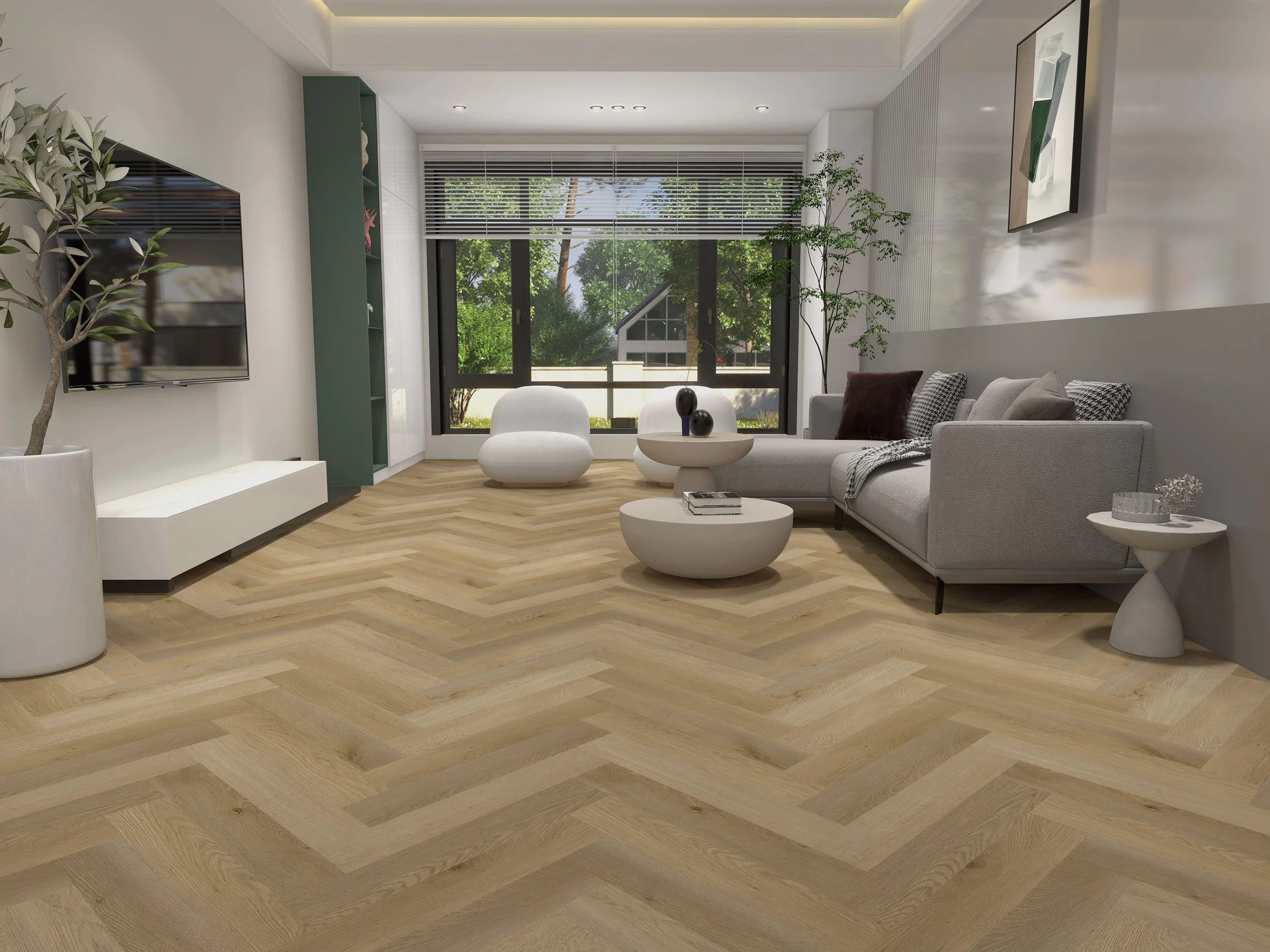 Sala de estar con sofá gris, mesa de centro redonda y plantas en las esquinas, ventana grande con vista a árboles verdes.