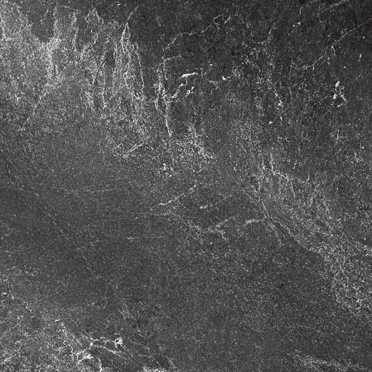 Superficie de mármol negro con vetas blancas y grises