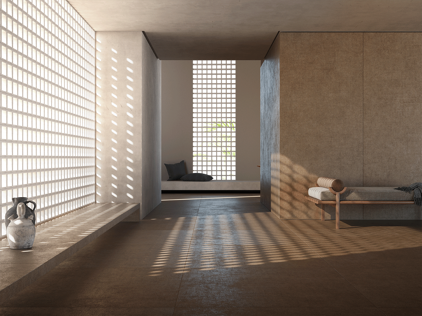 Interior de una habitación moderna con paredes de bloques de vidrio, una ventana con luz solar que crea sombras en el suelo, un banco con cojines en el fondo, y un banco de madera con toallas enrolladas y una manta