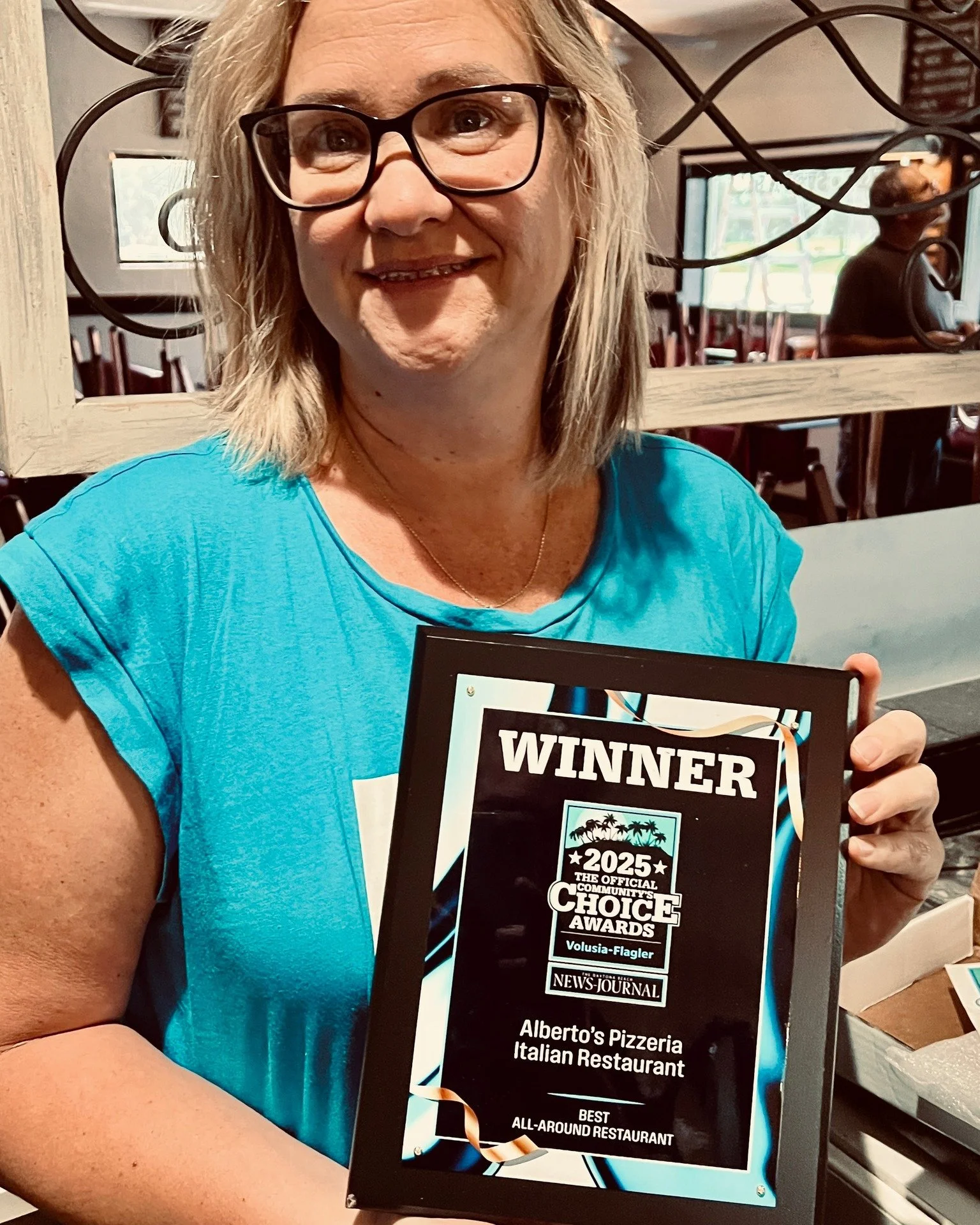 Owner Maria Holding Best Plaque.jpg