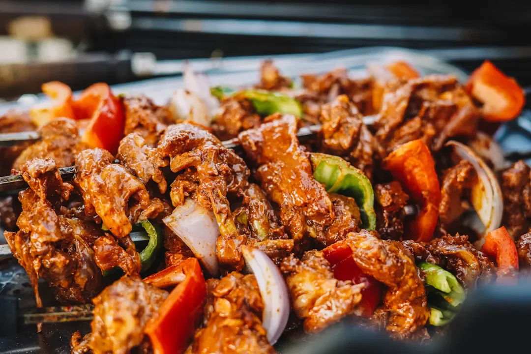 Meat and vegetable skewers with red and green bell peppers, and onions.