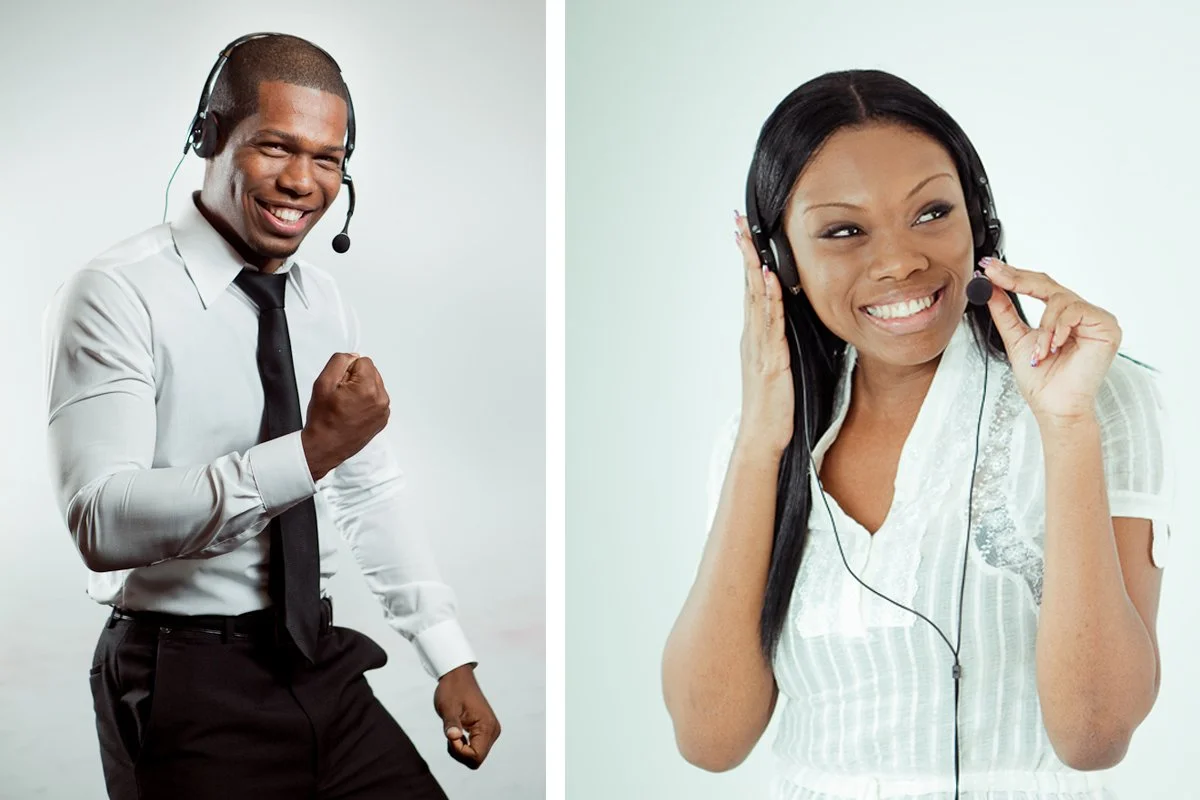 Two people wearing headsets, one man and one woman, smiling and appearing happy.