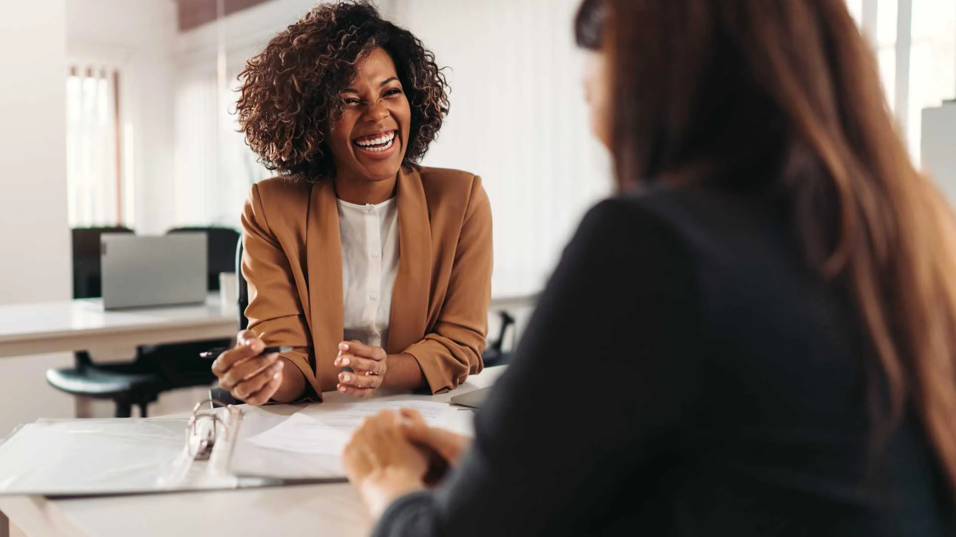 Two women consulting over a project
