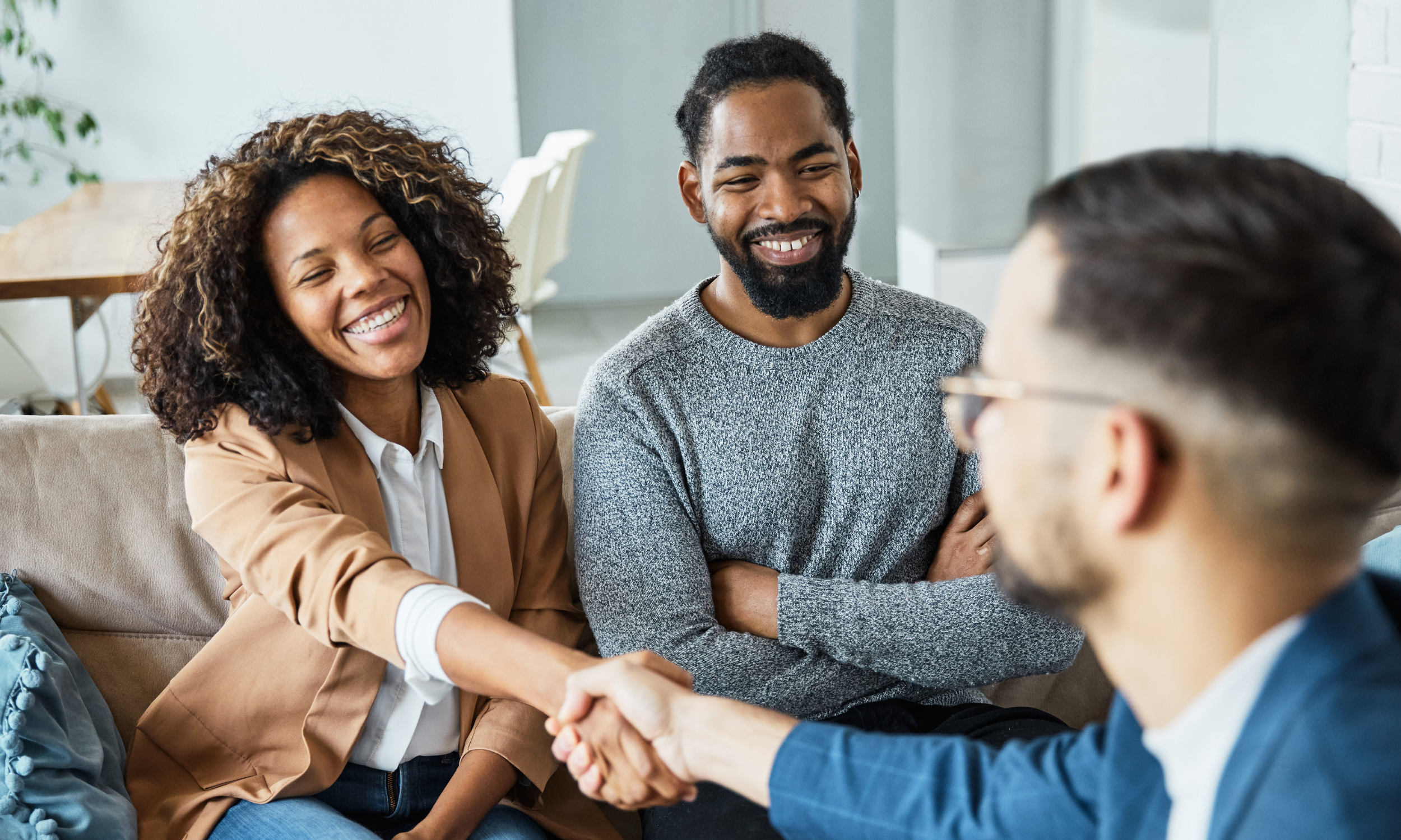Happy couple meeting with a social worker for a domestic adoption home study