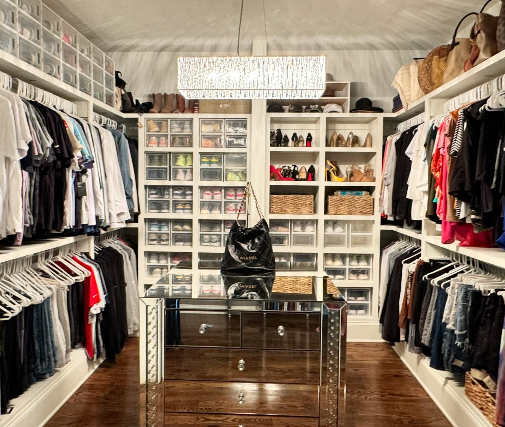 After shot an organized primary closet with labeled sections and color-coordinated clothing