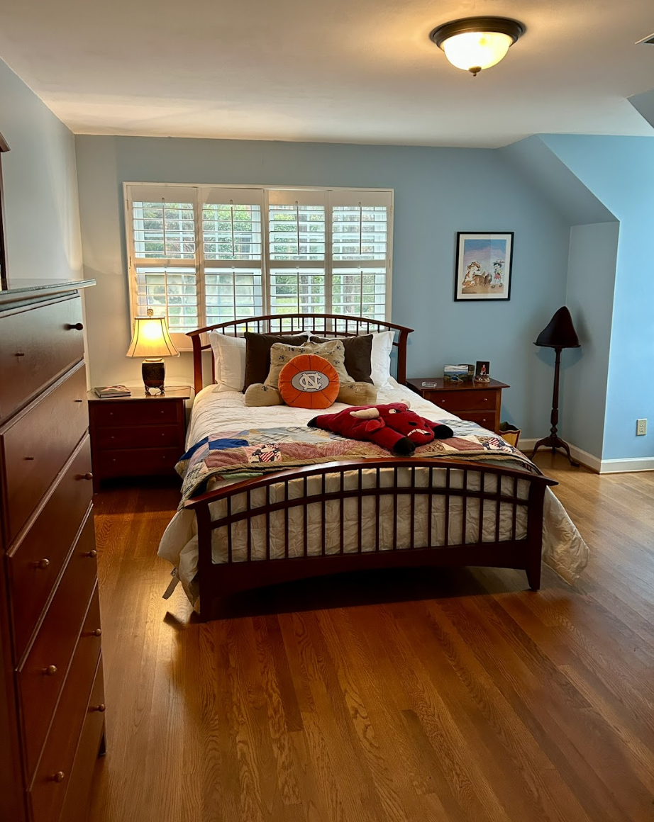 After shot of a decluttered and simplified bedroom by Orderly Oasis NC