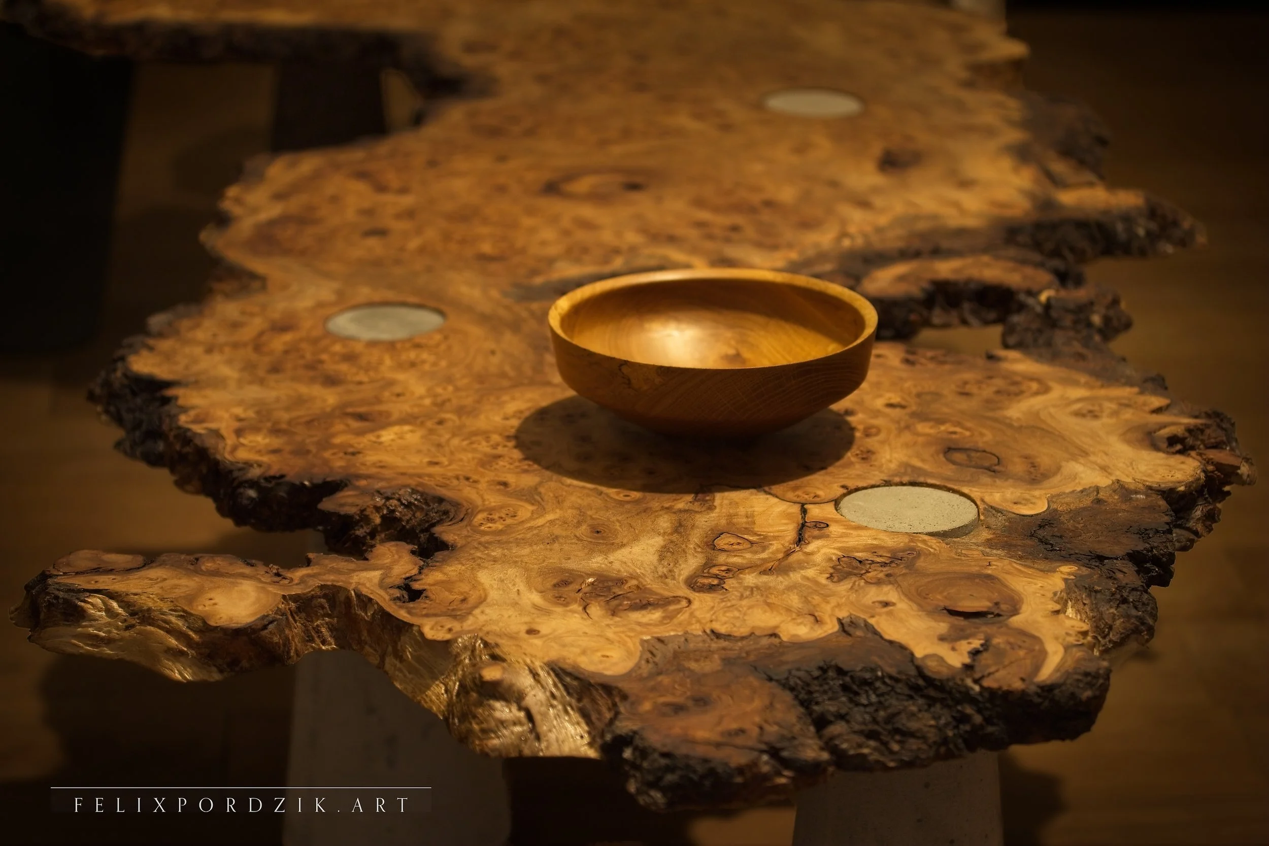 Japanese-inspired tea table with handcrafted bowl — handcrafted burl wood with concrete accents, combining craftsmanship and sculptural minimalism.