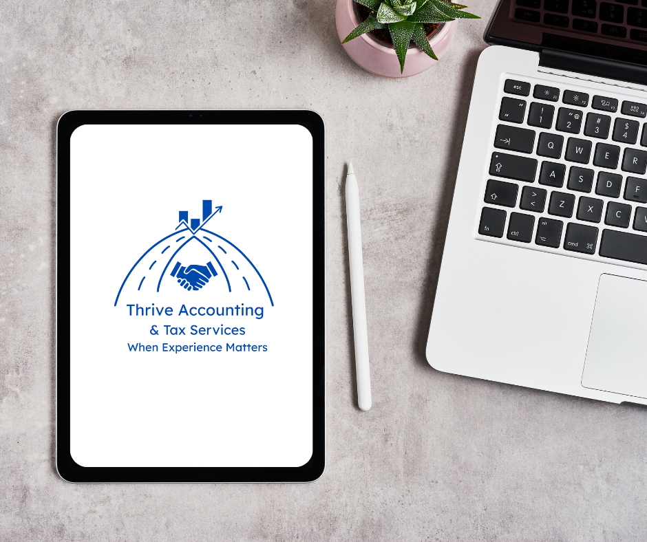 Tablet displaying the Thrive Accounting logo with a handshake atop a rising bar graph, placed on a light gray surface next to a white stylus pen, a laptop, and a potted succulent plant.