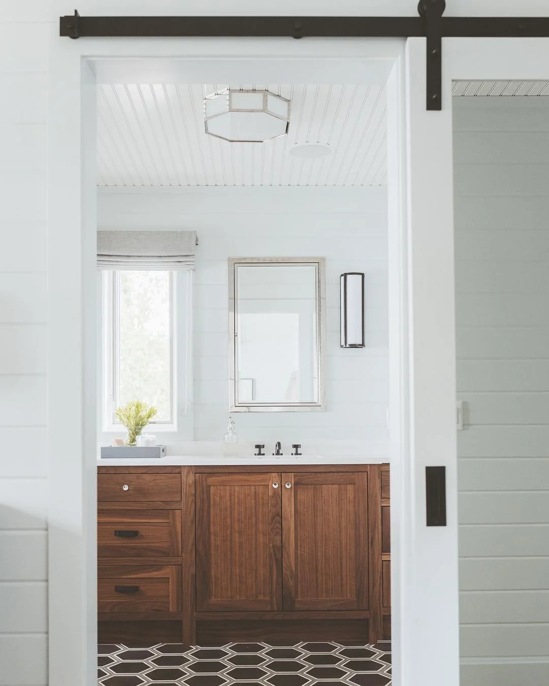 ...a peek into this lakeside master suite. can you tell the walls are painted the sliiightest hint of blue? 
design: @deluxedesignstudio 
photography: @paperantler .
.
.
#deluxedesignstudio #interiordesign #bathroomdesign #lakehouse #projectwaubesa