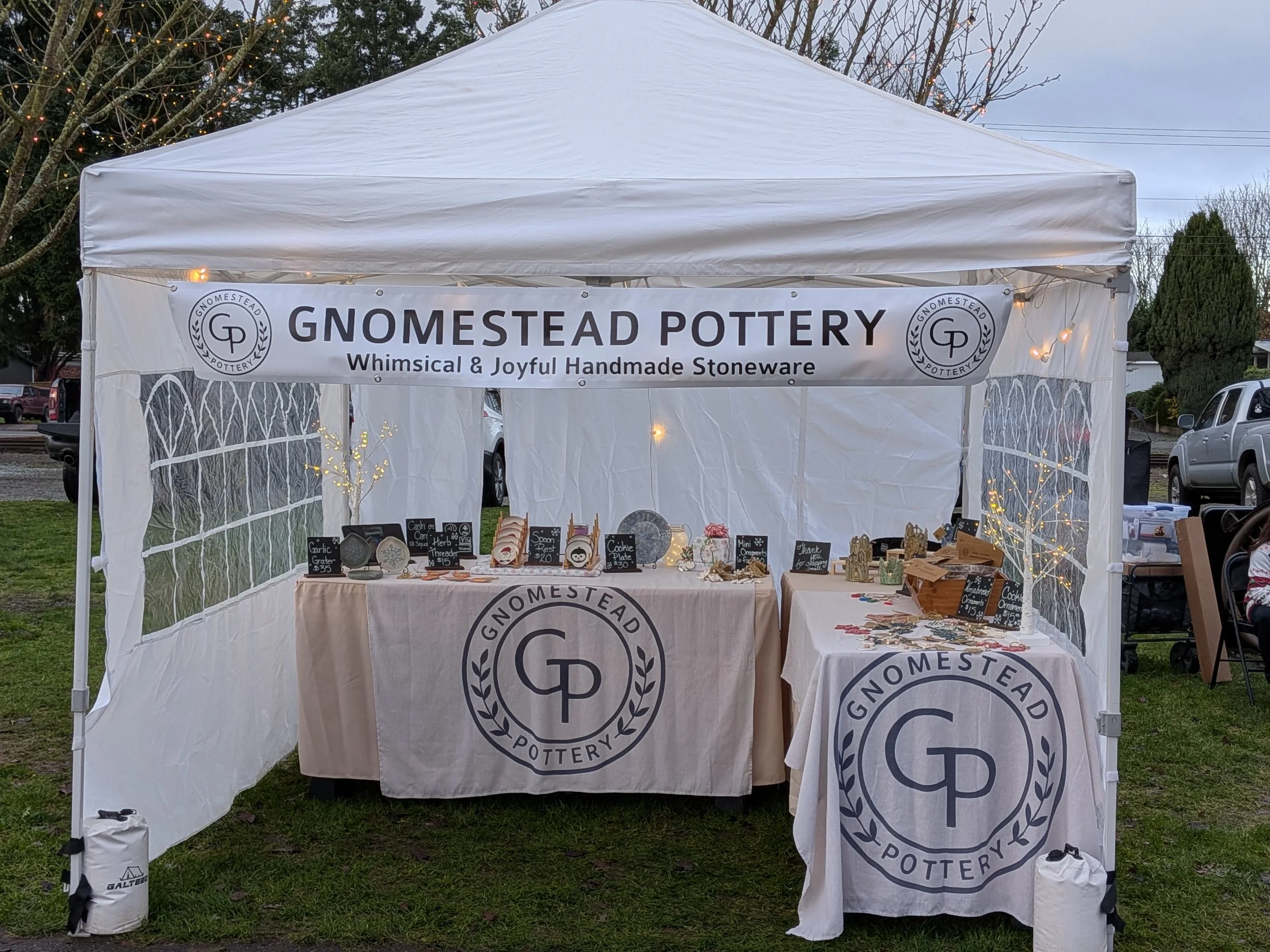 Booth setup showing pottery display at the Arlington Farmers Market Holly Days Market