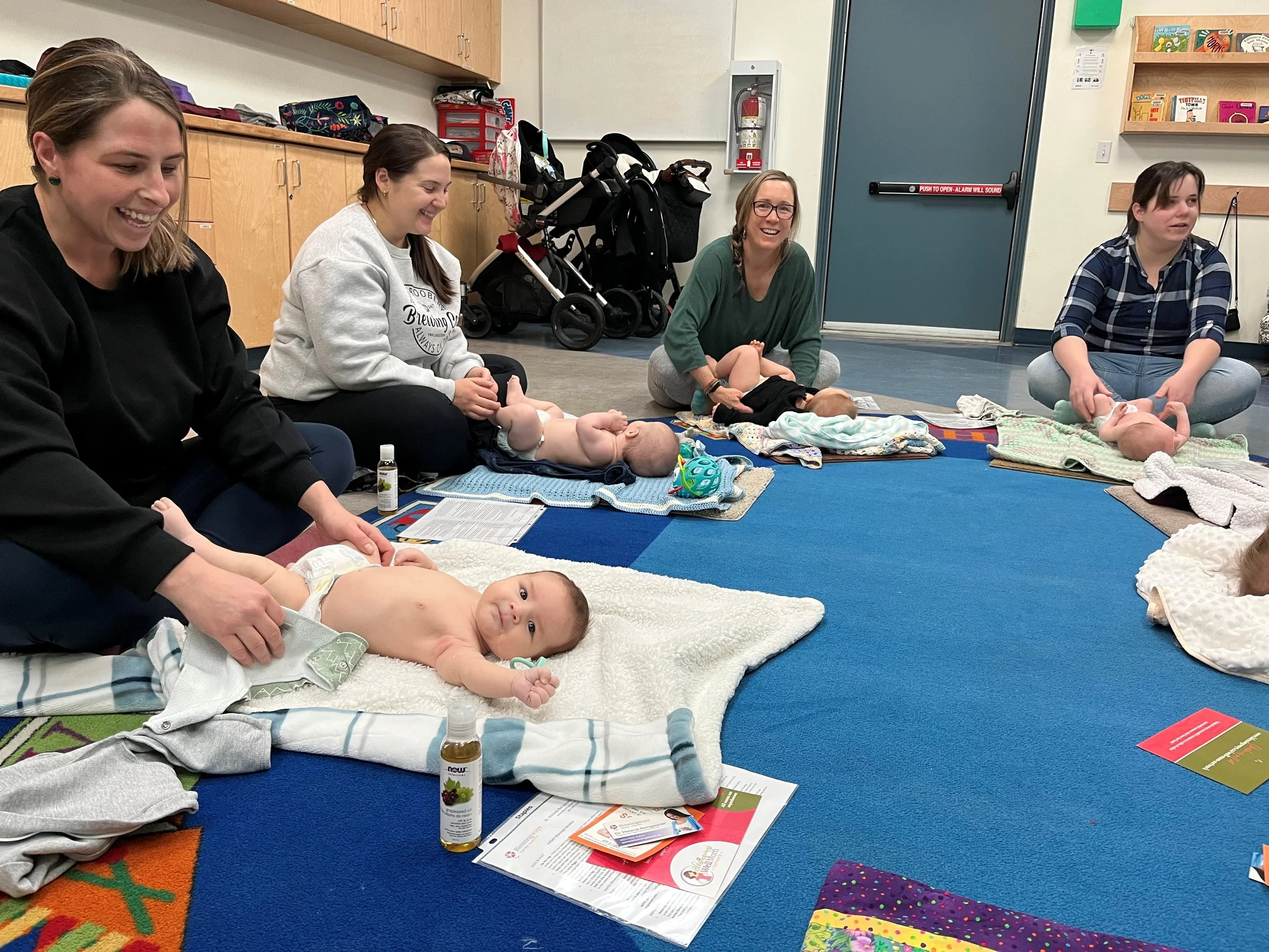 Baby massage class demonstrating how to set up a calm, comfortable space at home for baby massage, including blanket, oil, and warm environment