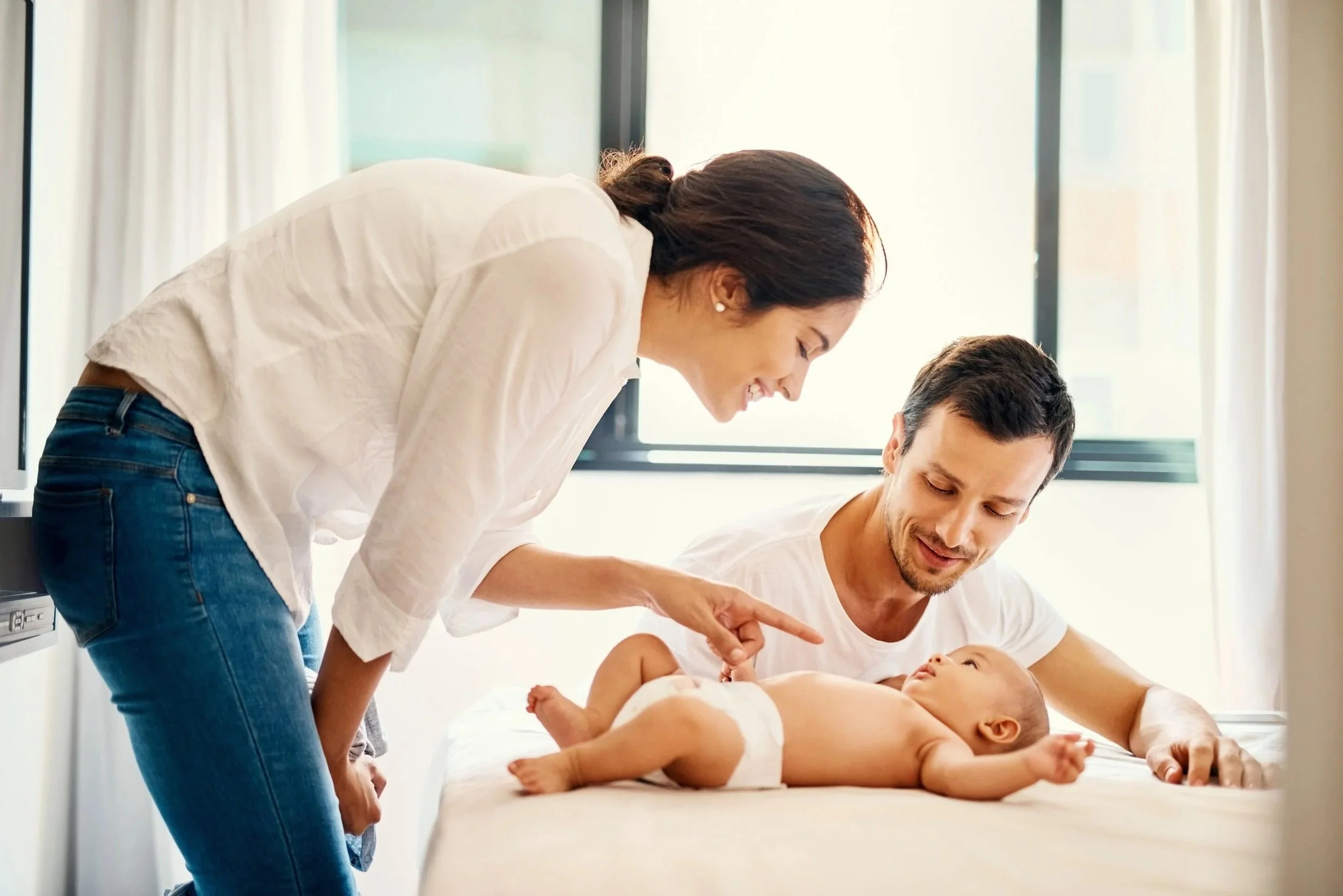 Parents learning baby massage together, showing how simple guidance helps build confidence and connection at home