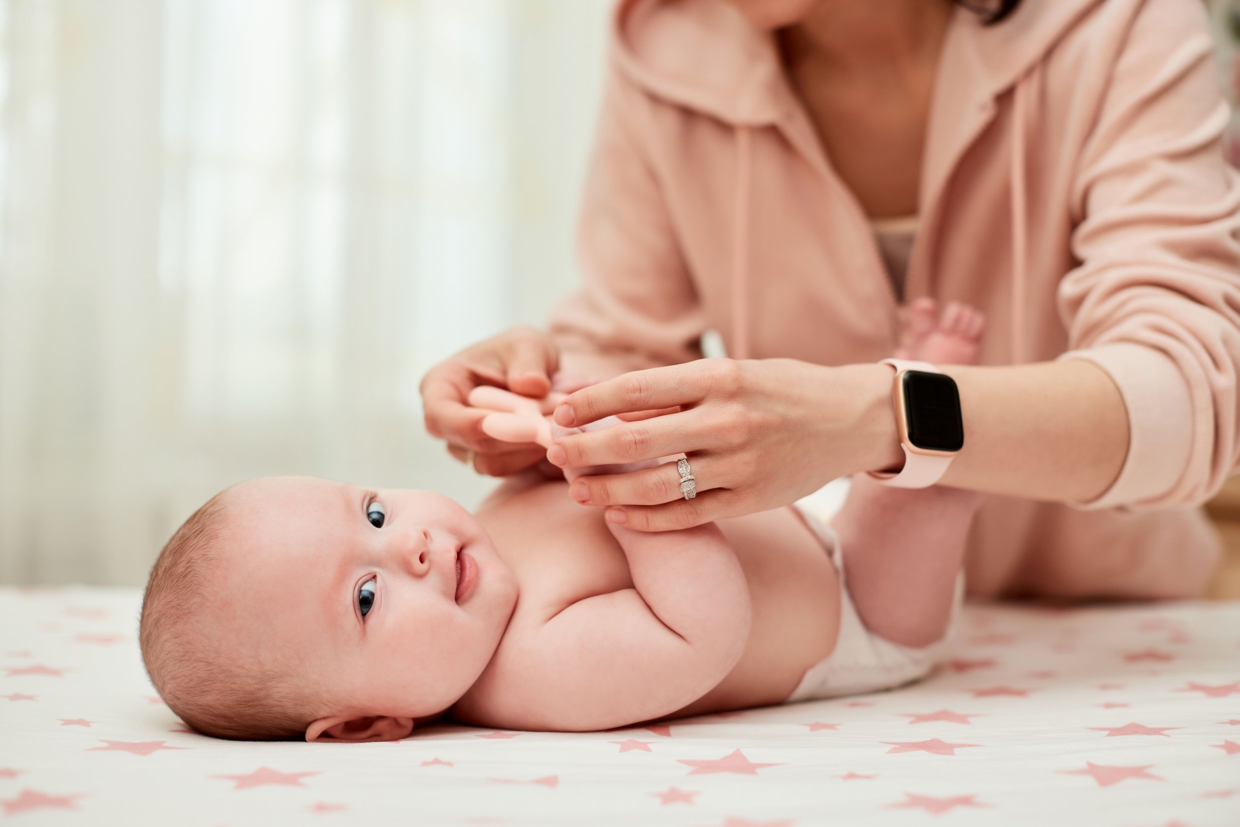 Mother giving baby massage, showing a meaningful baby shower gift that supports bonding, comfort, and connection