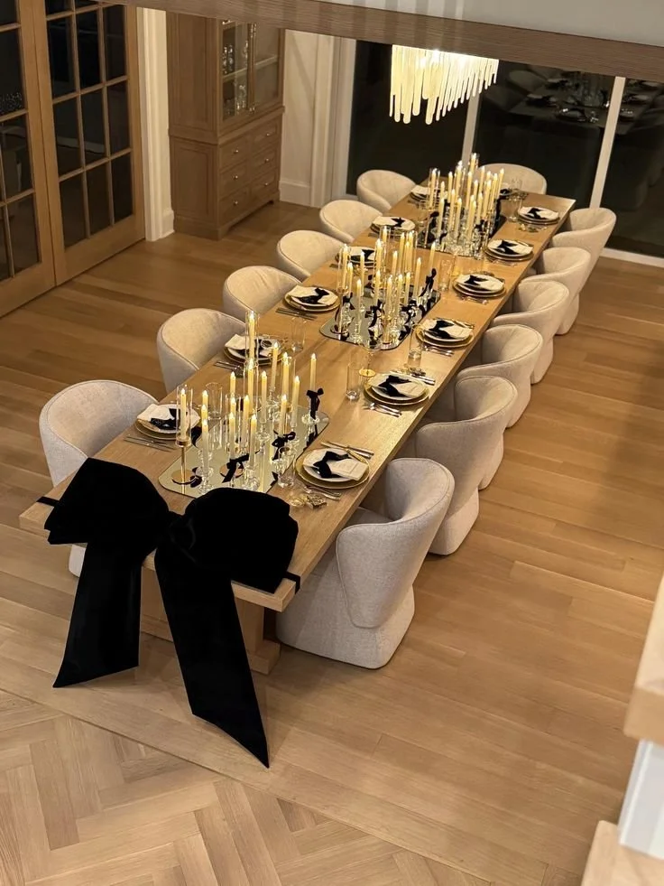 Elmo-themed birthday decoration with a backdrop featuring a green hedge design, colorful balloons in red, blue, yellow, and green, a large illuminated number one, and a sign reading '123 Happy Birthday.'