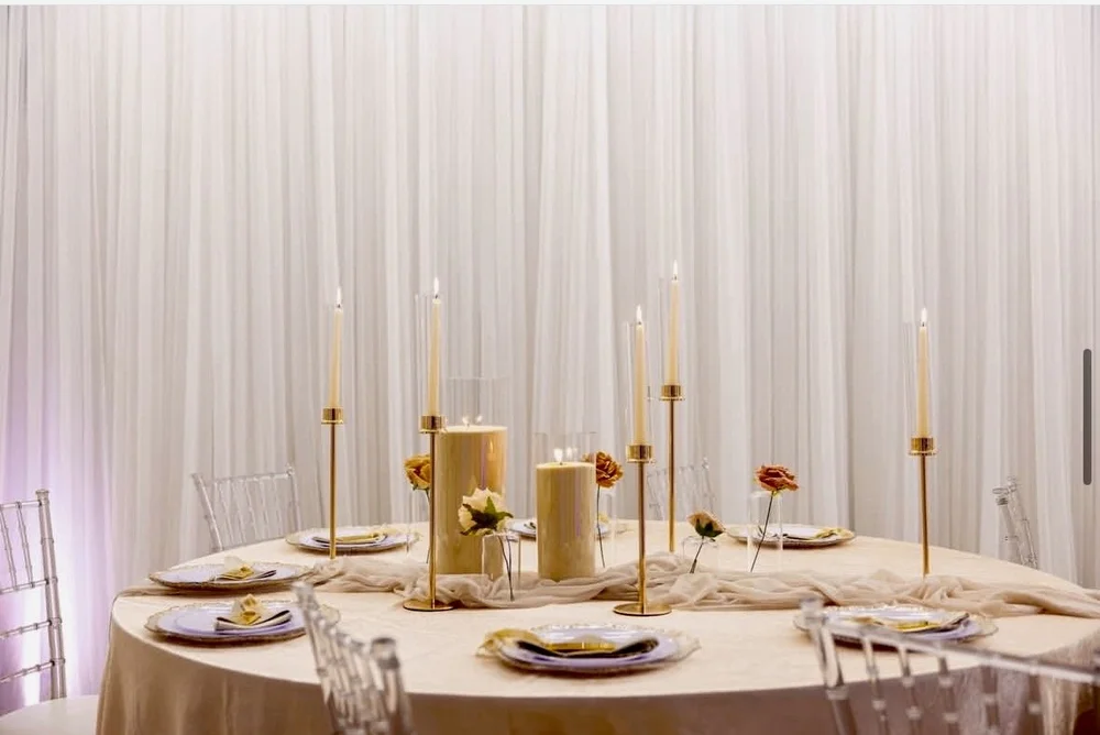 Elegant dining table setup with tall candles and white florals