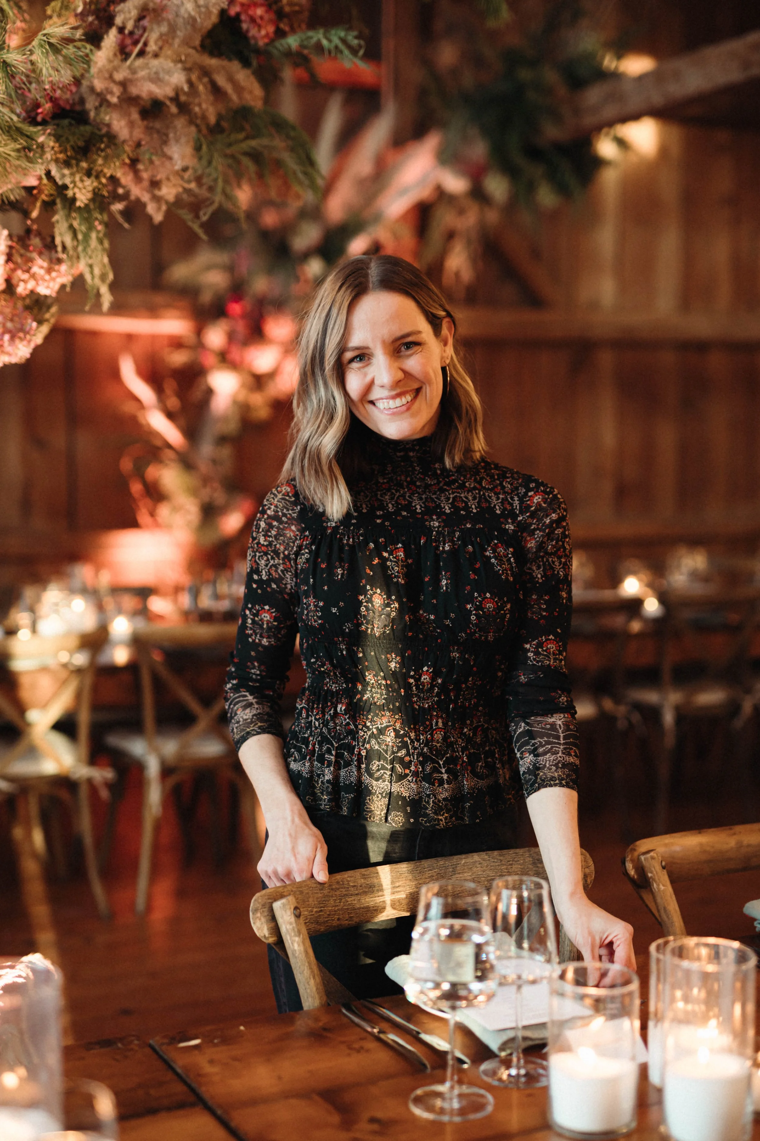 Owner of Flanagan Farm Essie Haimes smiles in front of a set dining table