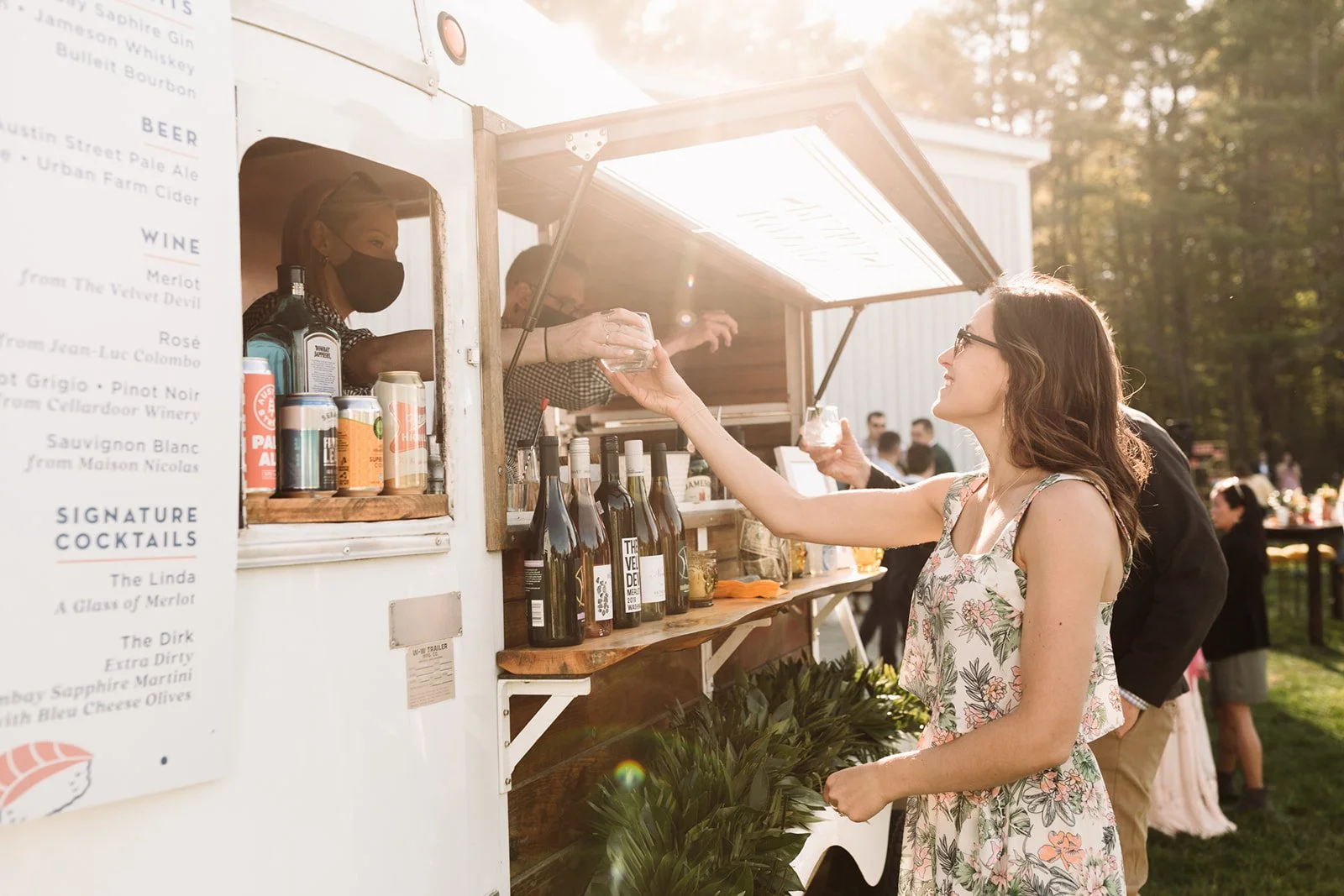 Guest receives a cocktail at Maine outdoor cocktail hour wedding