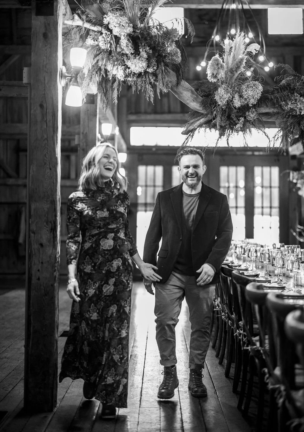 Owners of Flanagan Farm laughing in barn