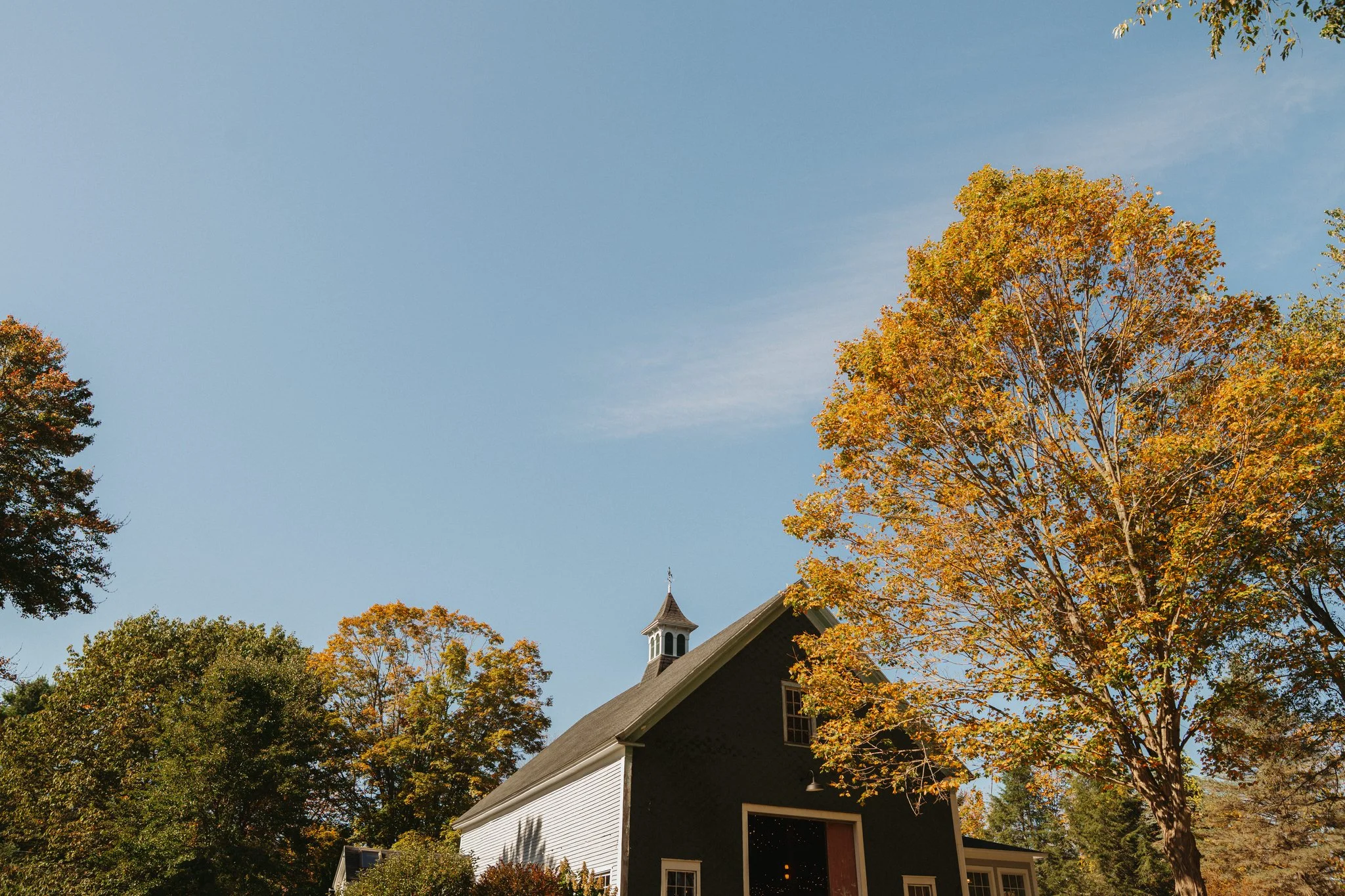 Landscape view of a wedding venue barn in Maine in autumn