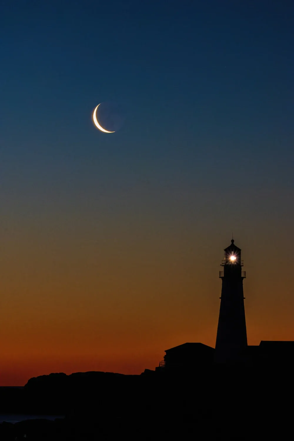 Portland Head Light with crescent moon