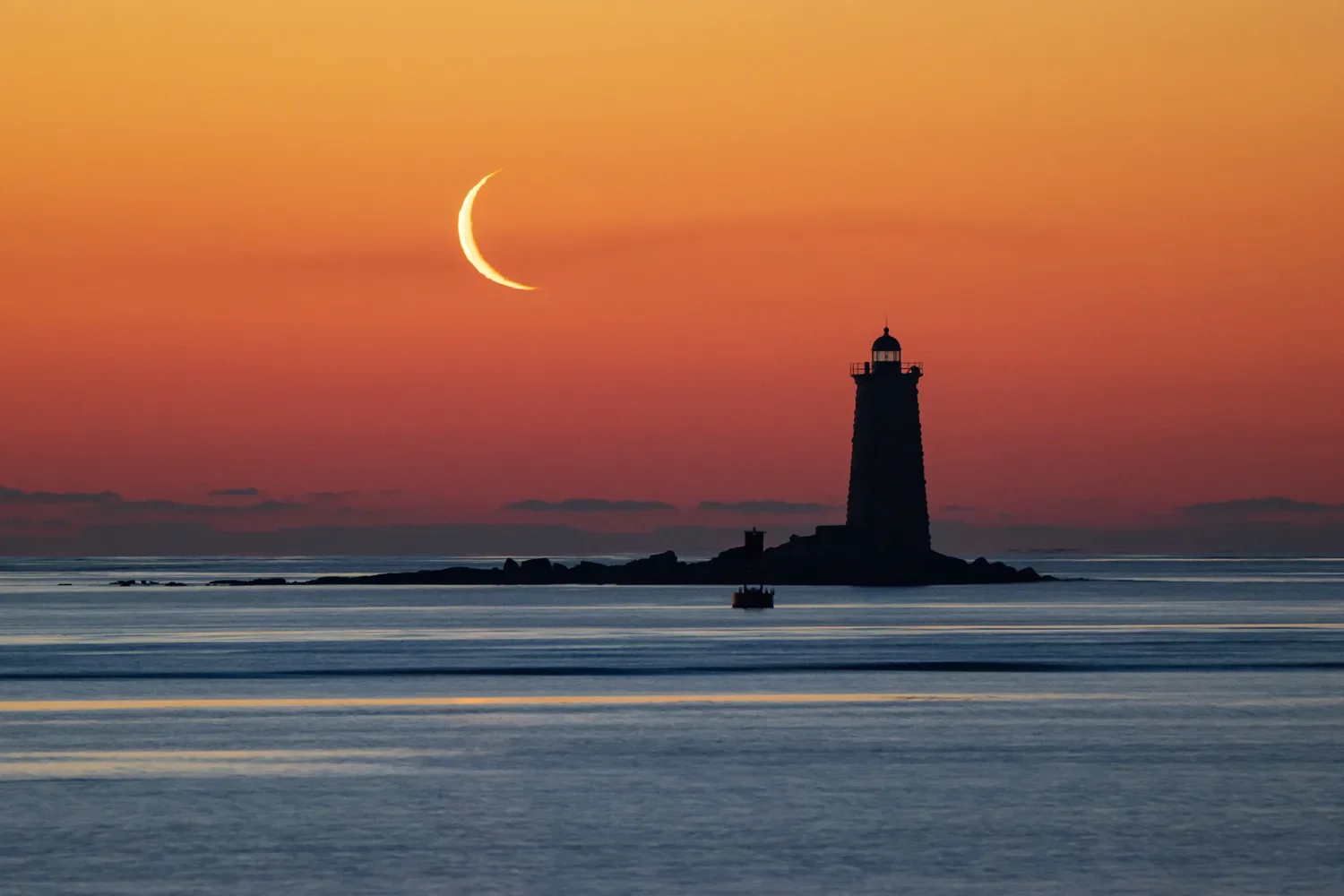 A crescent moon over Whaleback Light