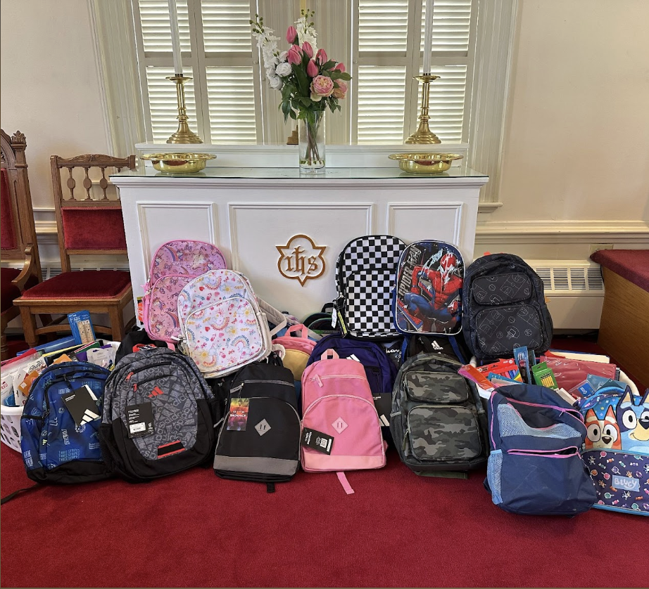 Backpacks lined up at the altar for a blessing