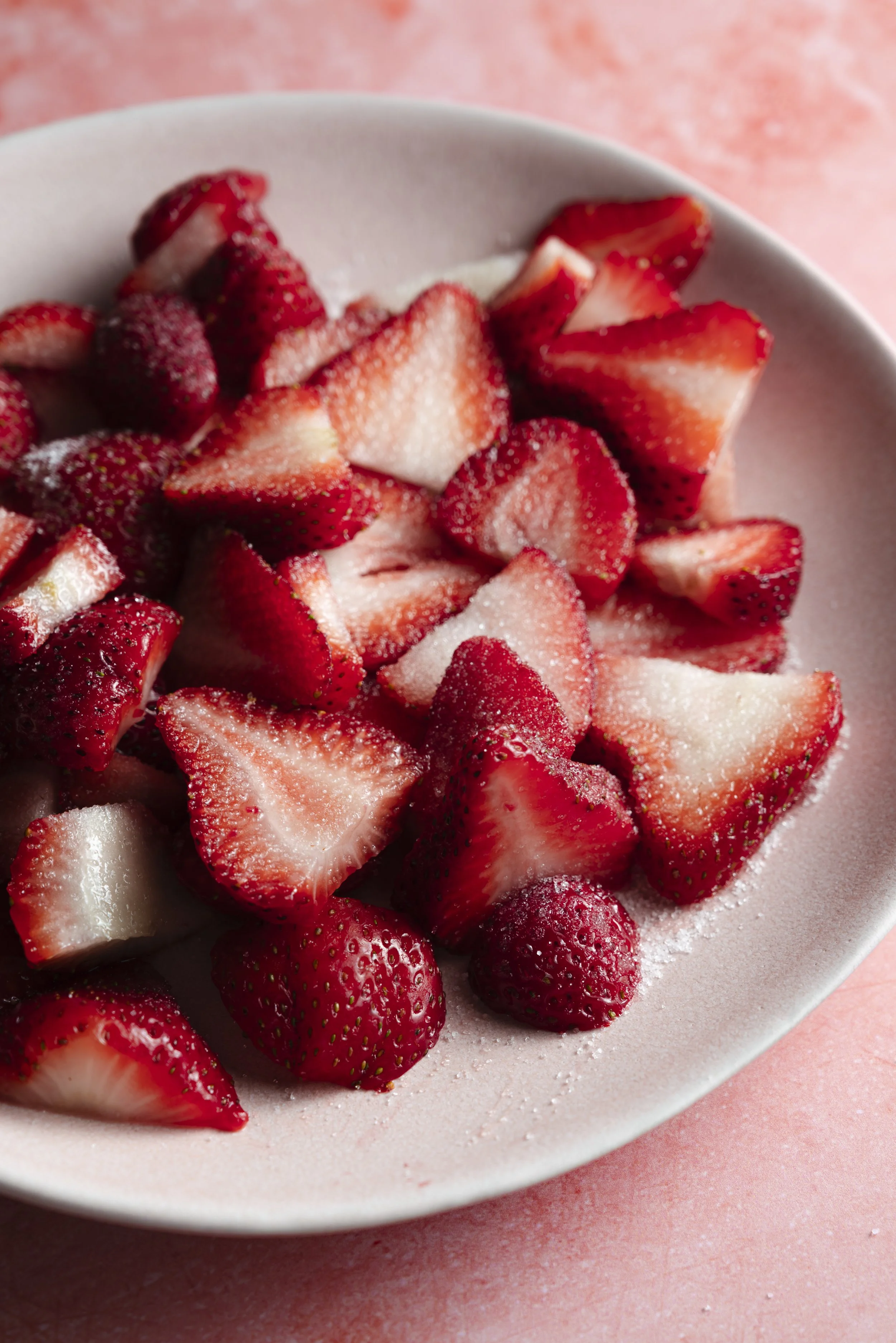 strawberry with sugar on pink background.jpg