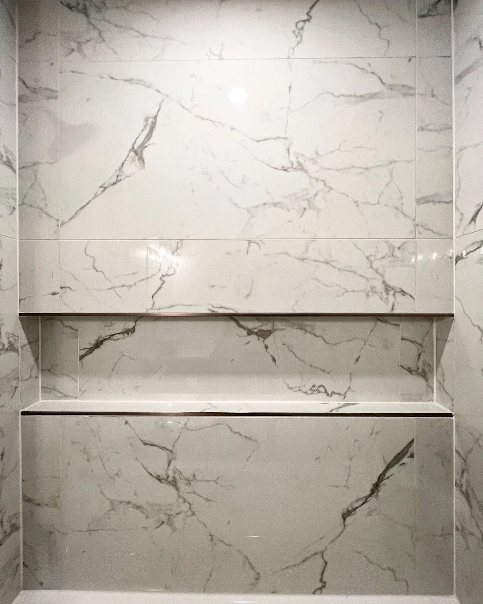 Marble wall with built-in shelves.