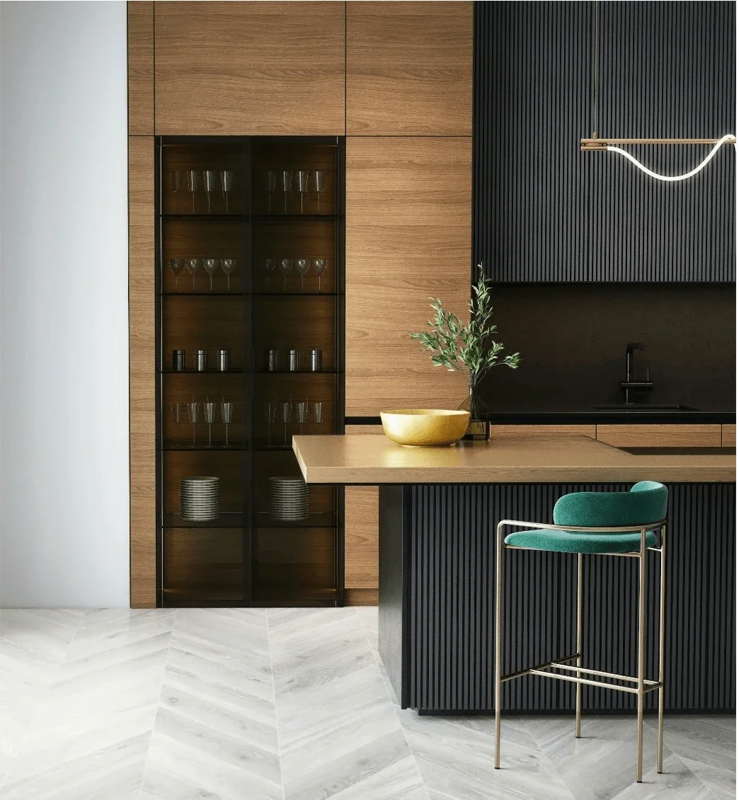 Contemporary kitchen with black and wood cabinetry, glass-fronted display cabinet, wooden countertop, green upholstered bar stool, and light-colored herringbone-patterned floor.