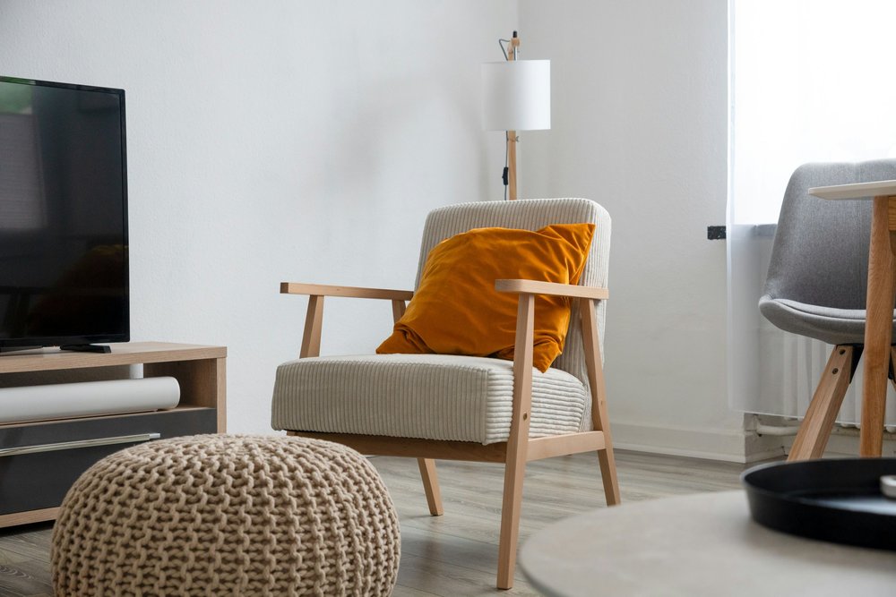 A comfortable chair in a calm, sunlit room