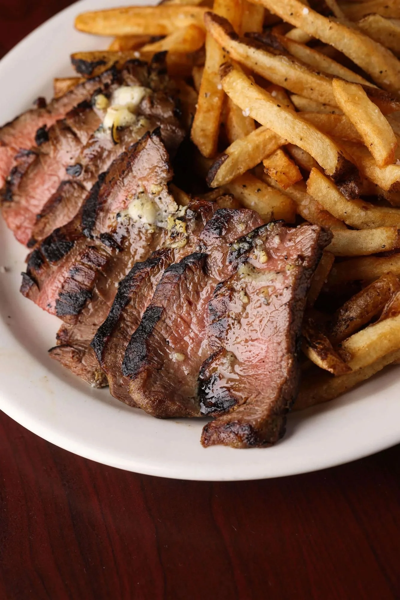 Steak Frites at Ryan's Wake: sliced, grilled flat iron steak topped with roasted garlic butter, with house-cut fries.