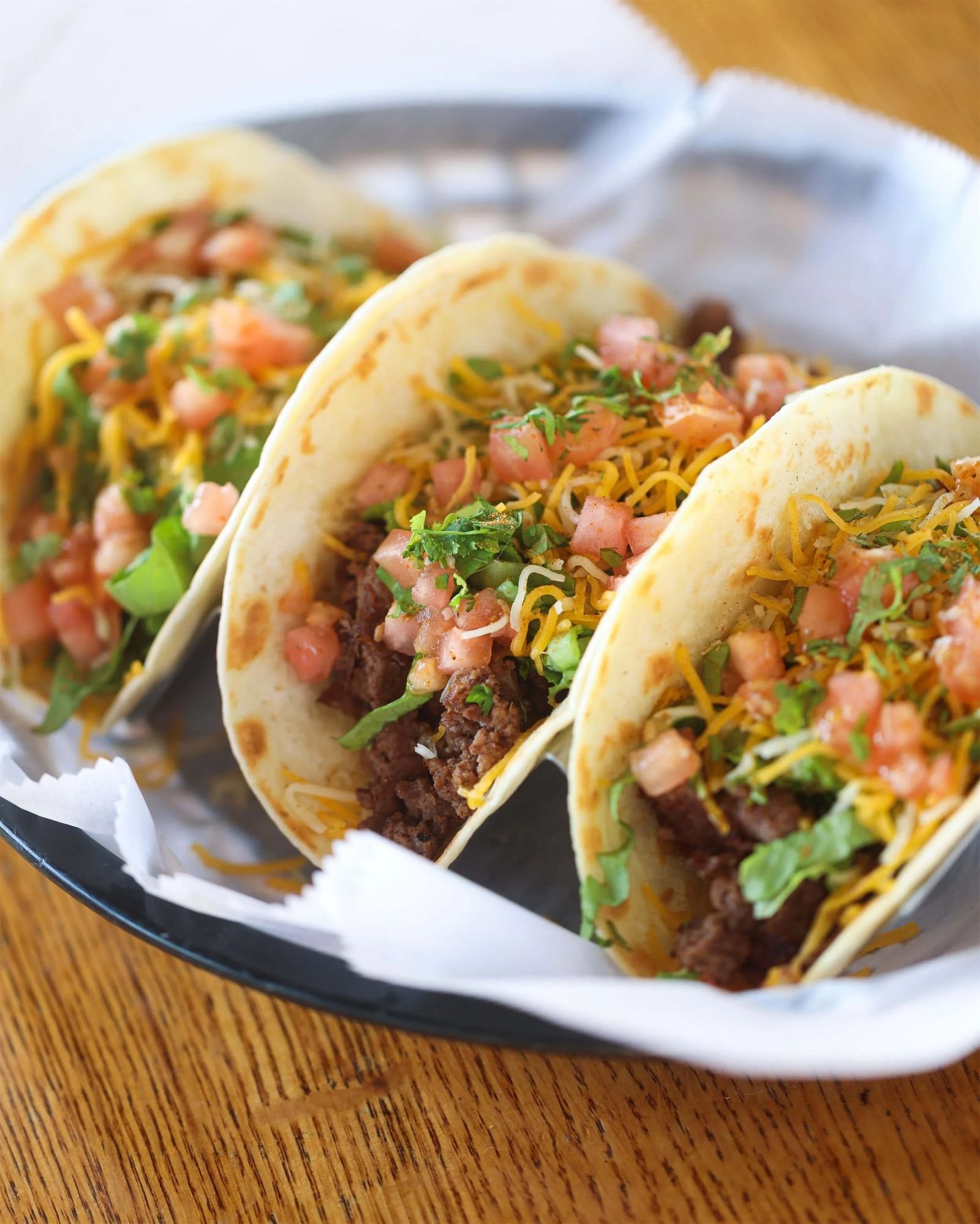 Brady Bunch Tacos at Ryan's Wake: three flour tortillas filled with seasoned ground beef, cheddar jack cheese, lettuce, and diced tomato.