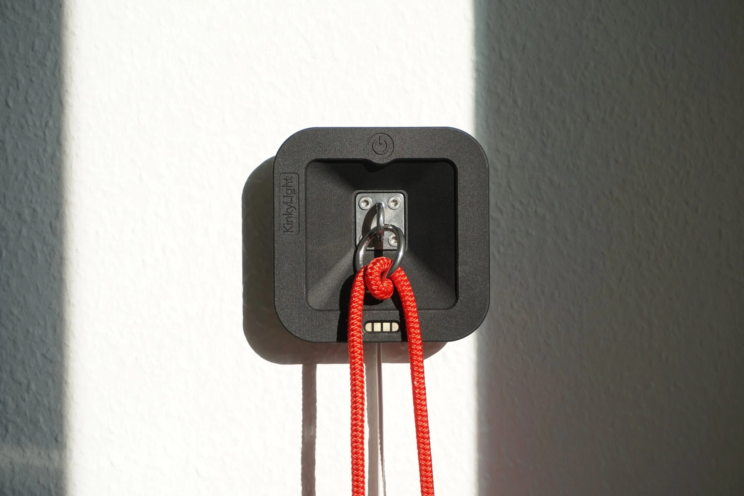 Cover removed and the light visible with a red rope secured by a metal hook.