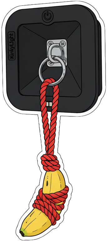 A 2D sticker drawing of a wall-mounted bedside lamp with a banana attached by a red rope tied around it, hanging from the lights metal ring.