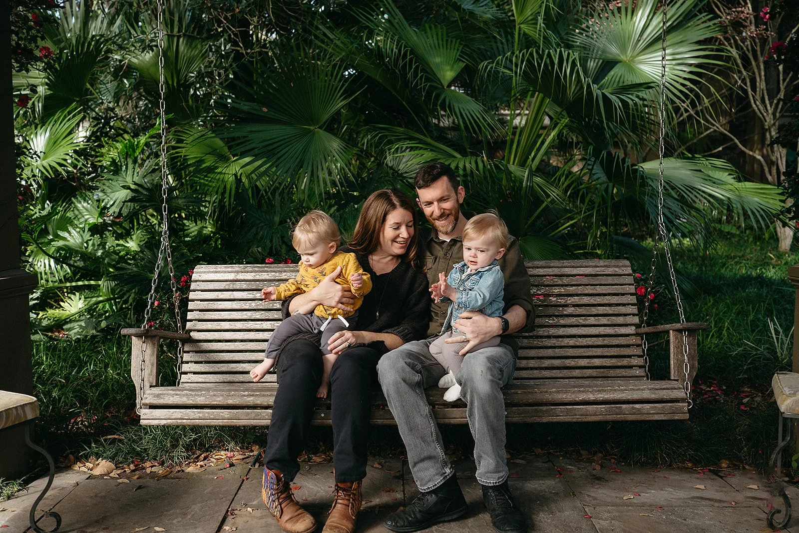 Family sitting for a photo in the Meditation Garden at Audubon Park, New Orleans