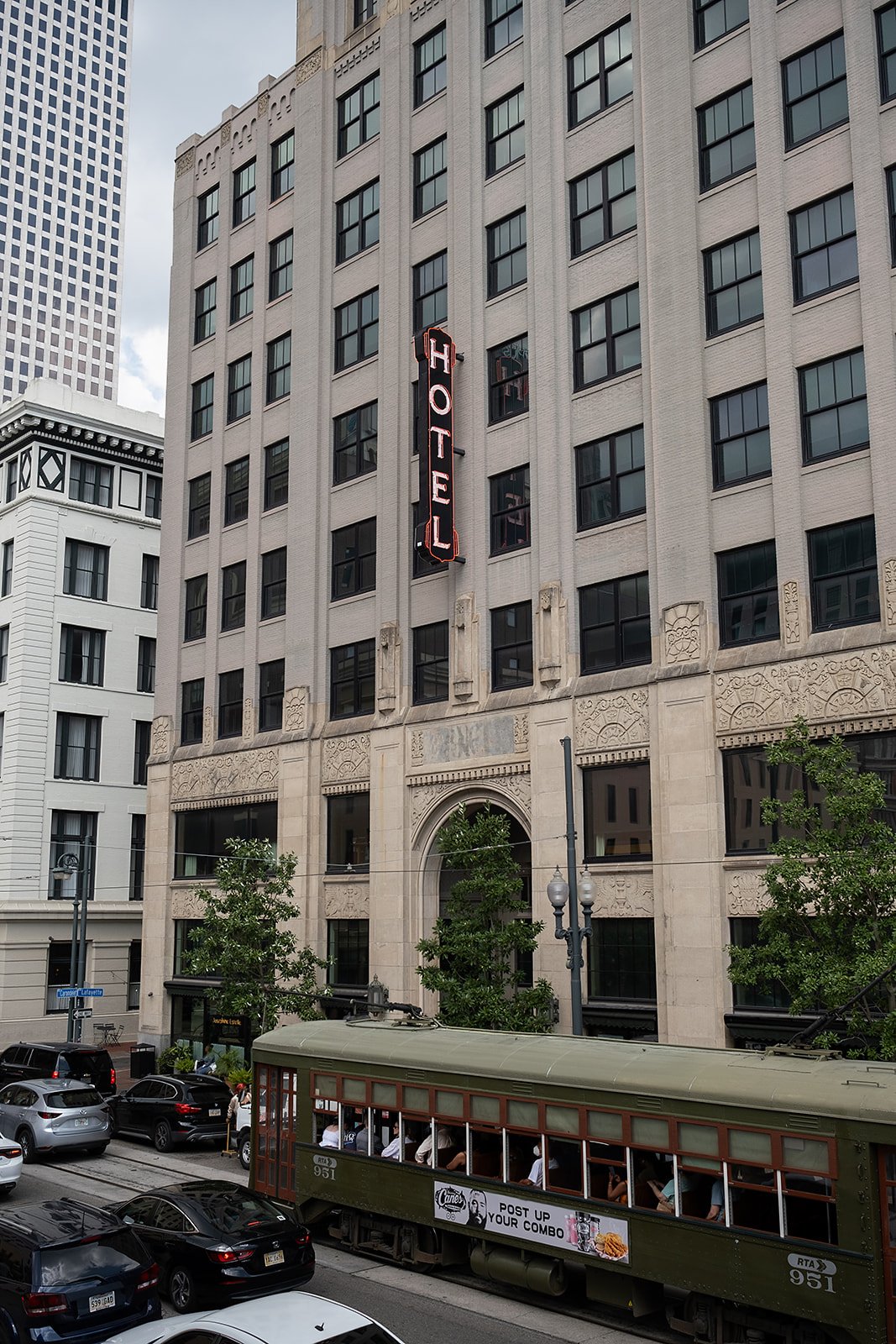 Green line Street car driving past The Barnett - JDV by Hyatt in the New Orleans CBD