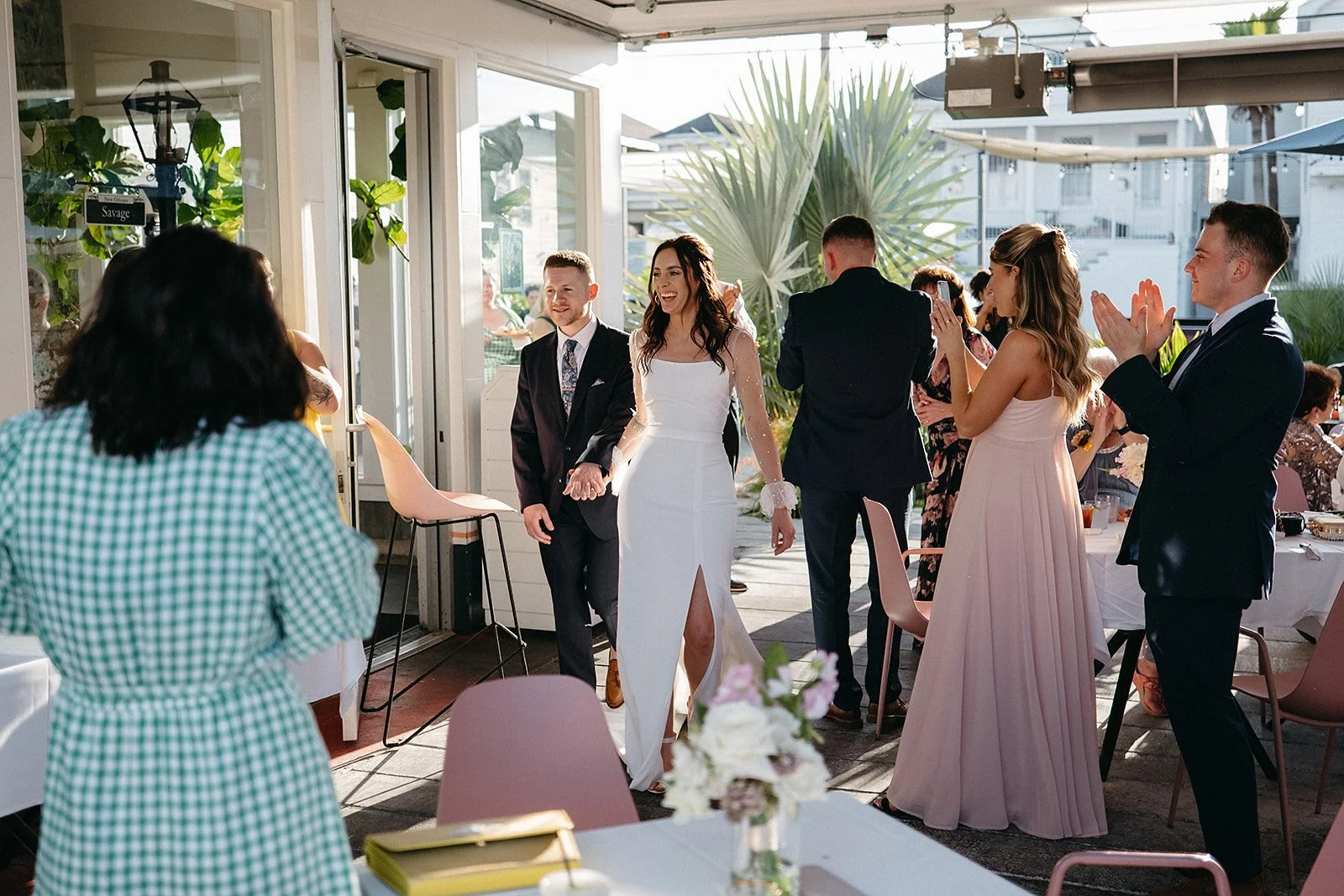 Bride and groom making their entrance to the wedding reception being held at Val's on Freret Street, New Orleans