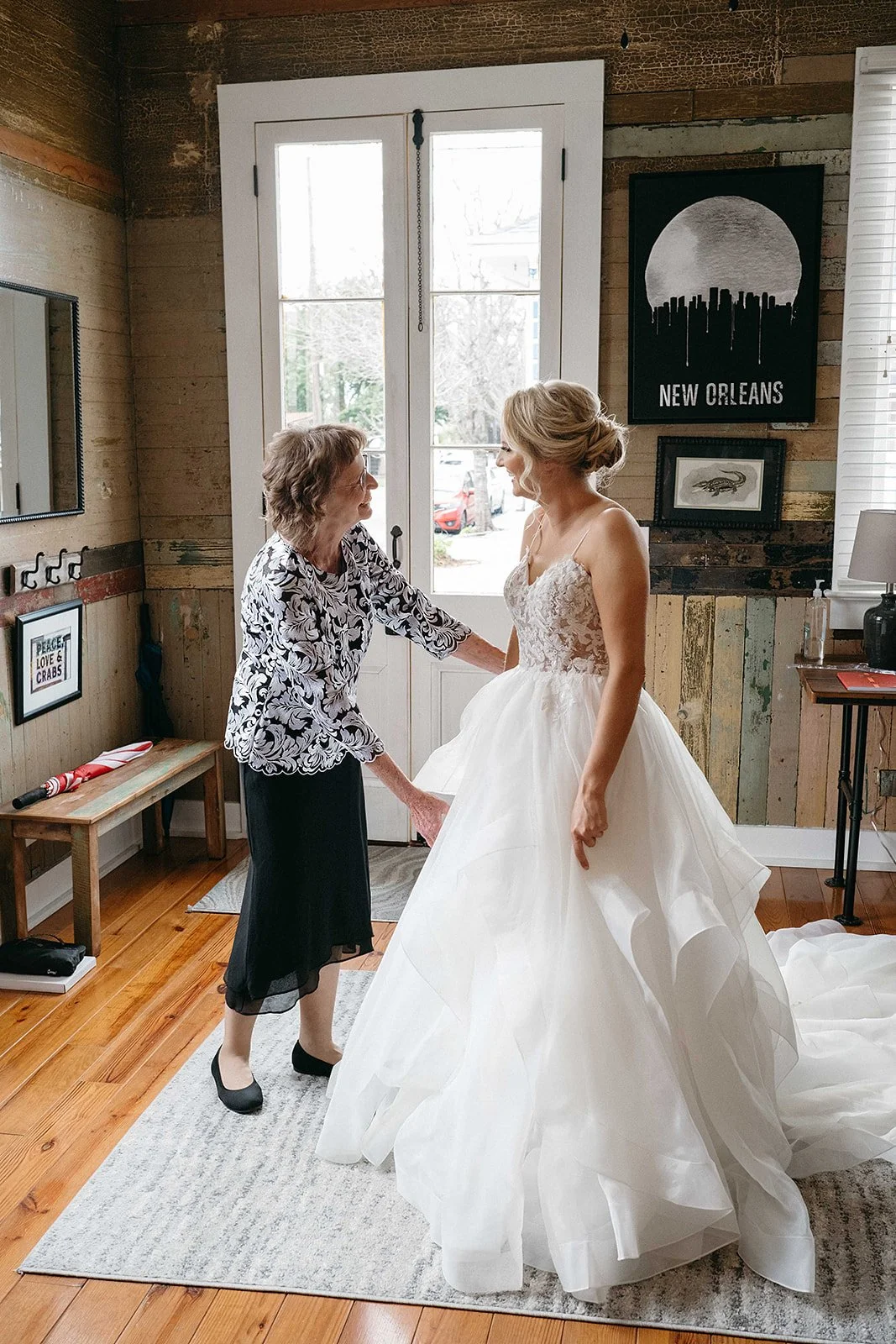 Bride and her mother on the wedding day getting ready and putting on the wedding dress.  Photo was in the Bywater in New Orleans.