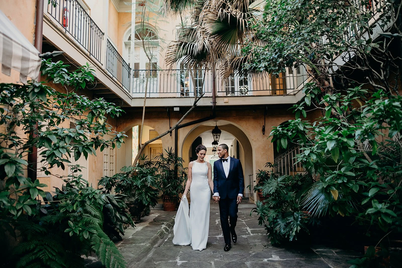 Bride and groom stealing a moment together in a French Quarter hidden courtyard in New Orleans on their wedding day.