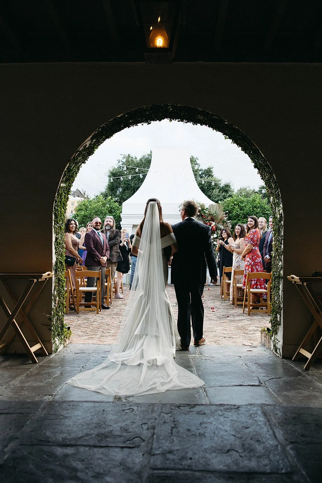 Bride being walked down the aisle at Il Mercato in the Lower Garden District in New Orleans