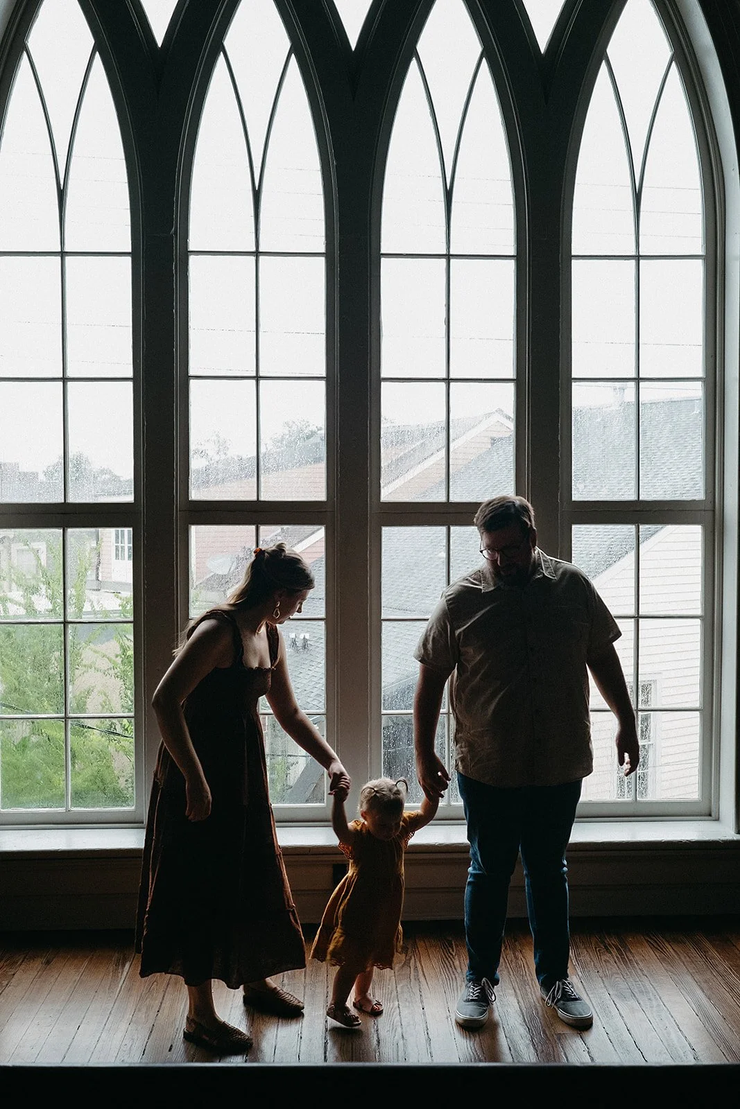 Silhouettes of a family during their family photo session at Felicity Church in the Lower Garden district, New Orleans