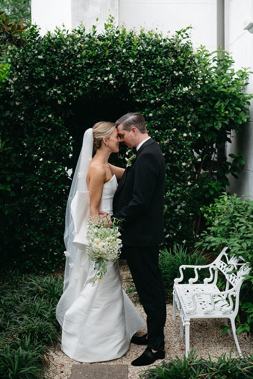 Bride and groom having an intimate moment in the side garden at The Felicity Church in the Lower Garden District, New Orleans
