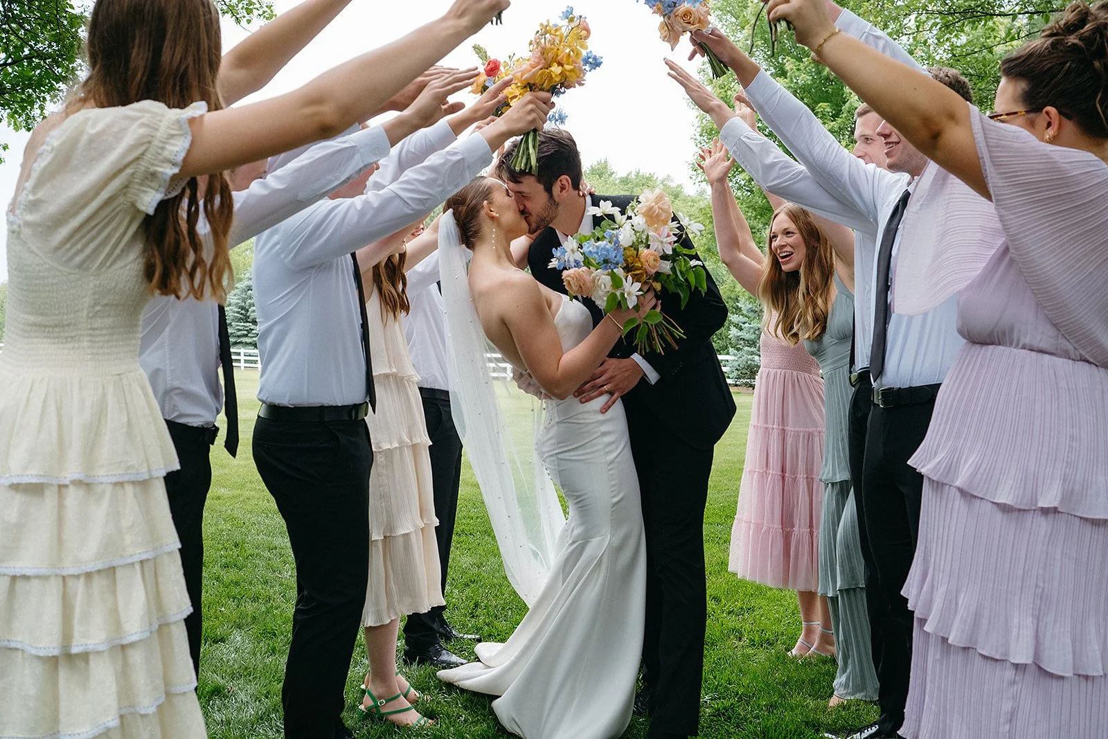 Bride and groom celebrating saying I'd do with the entire wedding party.