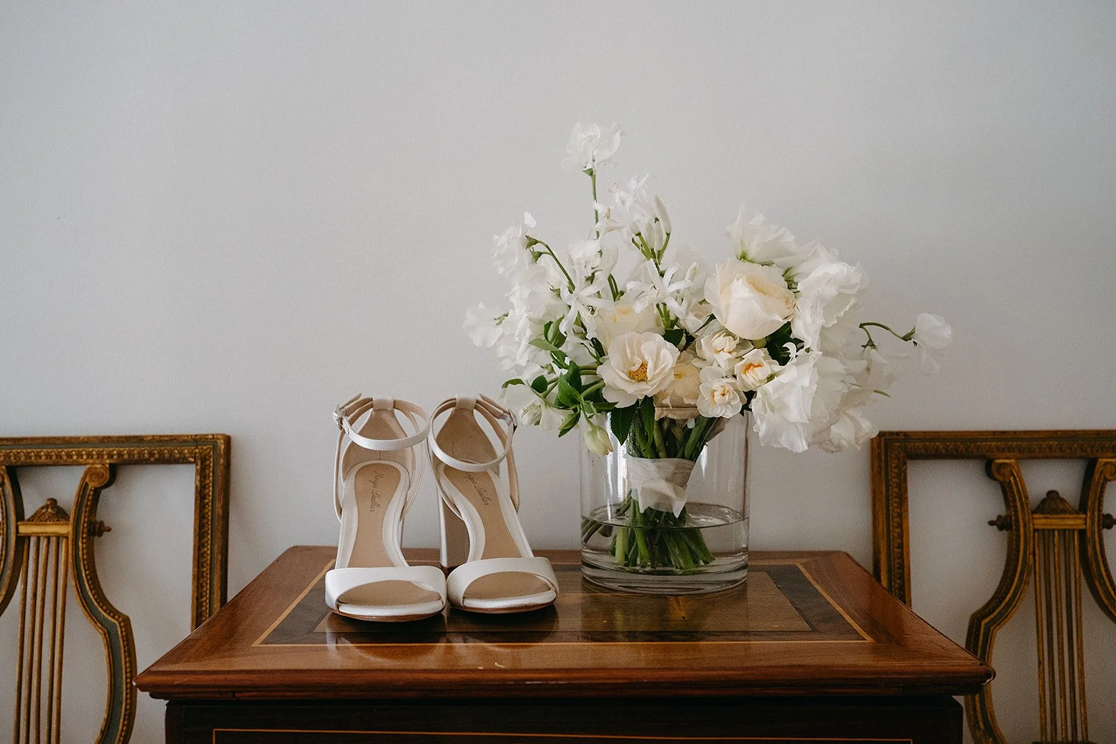 Wedding day details of bride's shoes and bouquet, New Orleans